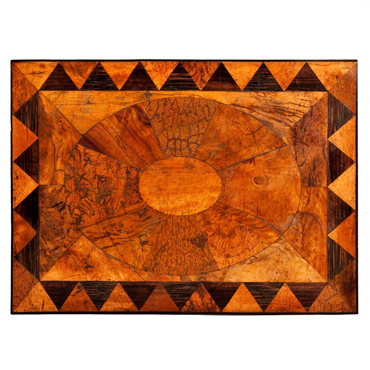 This occasional, lamp or end table is typical of a group of high quality, vibrantly-inlaid tables produced in the Galle District from the early 19th century, based on Regency designs, displaying a wide variety of indigenous timbers in a distinctive
