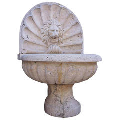 Italian Stone Fountain with Carved Lion Face Against a Shell Background