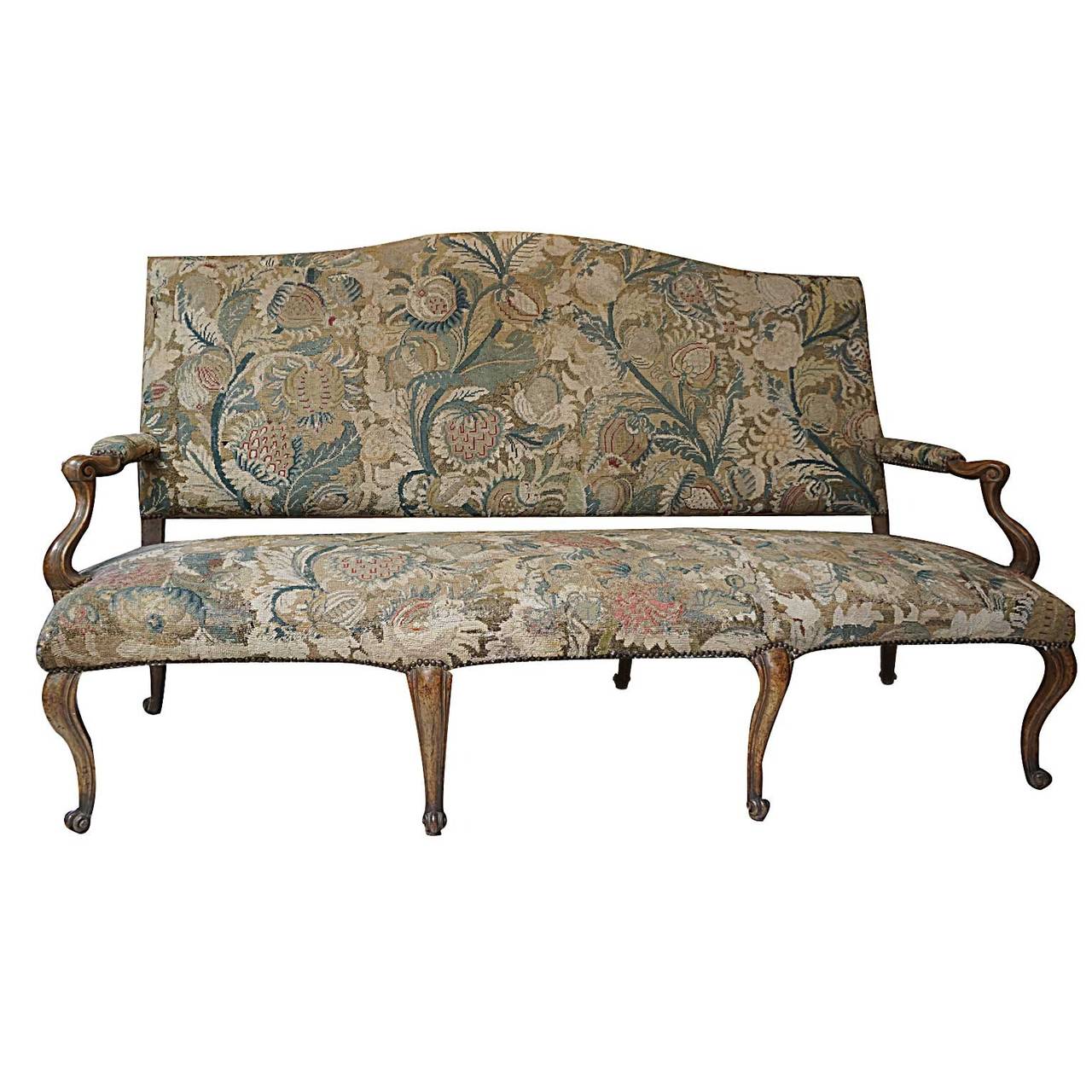18th century Italian sofa with beautifully carved walnut frame and finely carved cabriole legs with a warm patina. The tapestry upholstery is from the late 18th century-early 19th century and has been removed from the frame, cleaned, restored and