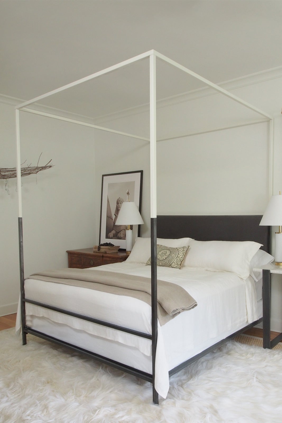 This ultra-sleek and streamlined two-tone iron canopy bed with upholstered headboard from the custom Tara Shaw Maison collection has been featured in several shelter magazines, including Veranda and Architectural Digest. Handcrafted in New Orleans.