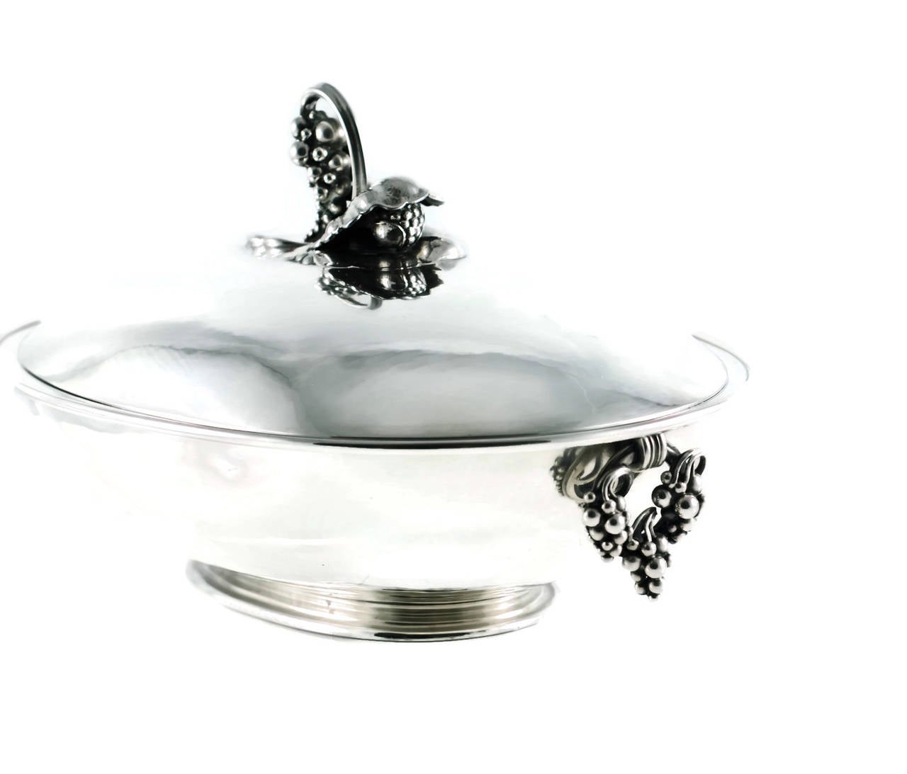 Vintage Georg Jensen sterling silver oval serving dish with cover - grape motif. This fabulous pre 1945 Georg Jensen oval lidded dish is crafted from sterling silver. The hand-hammered dish is a wonderful example of Jensen's iconic Grape Collection,
