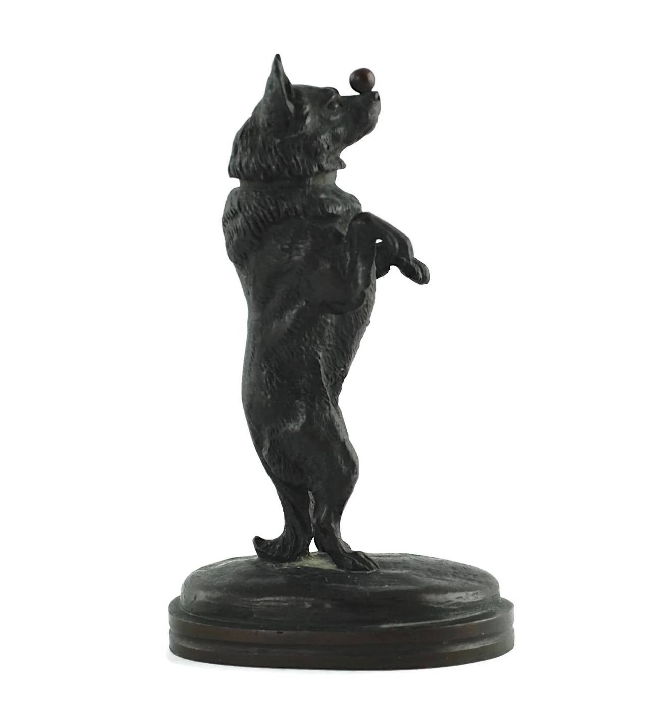 This bronze sculpture is by French artist, Joseph Victor Chemin (1825-1901). Chemin is particularly well known for his realistically modeled bronze dogs shown at work and at play. This circa 1870 piece is titled 'Chien au Sucre' translated as 'Sugar