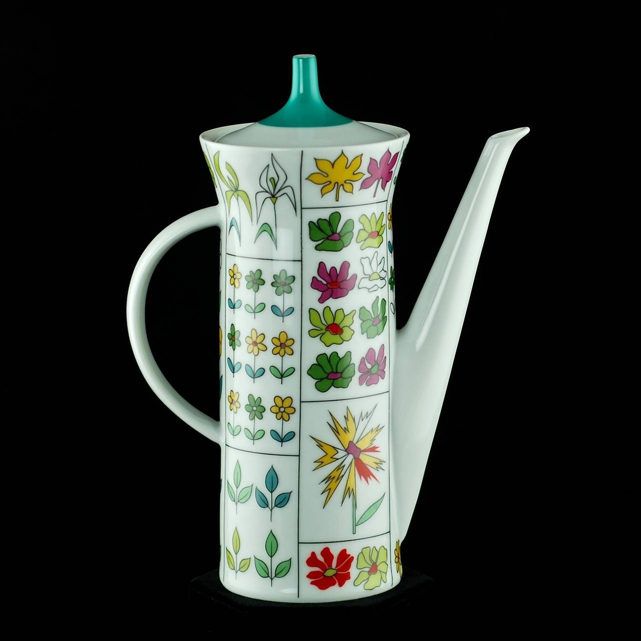This vintage coffee set was made by German porcelain manufacturer, Rosenthal. The pieces have a Classic Mid-Century look with forms designed by Hans-Theo Baumann. The set has been finished in Rosenthal's vibrant floral 'Piemonte' pattern, designed