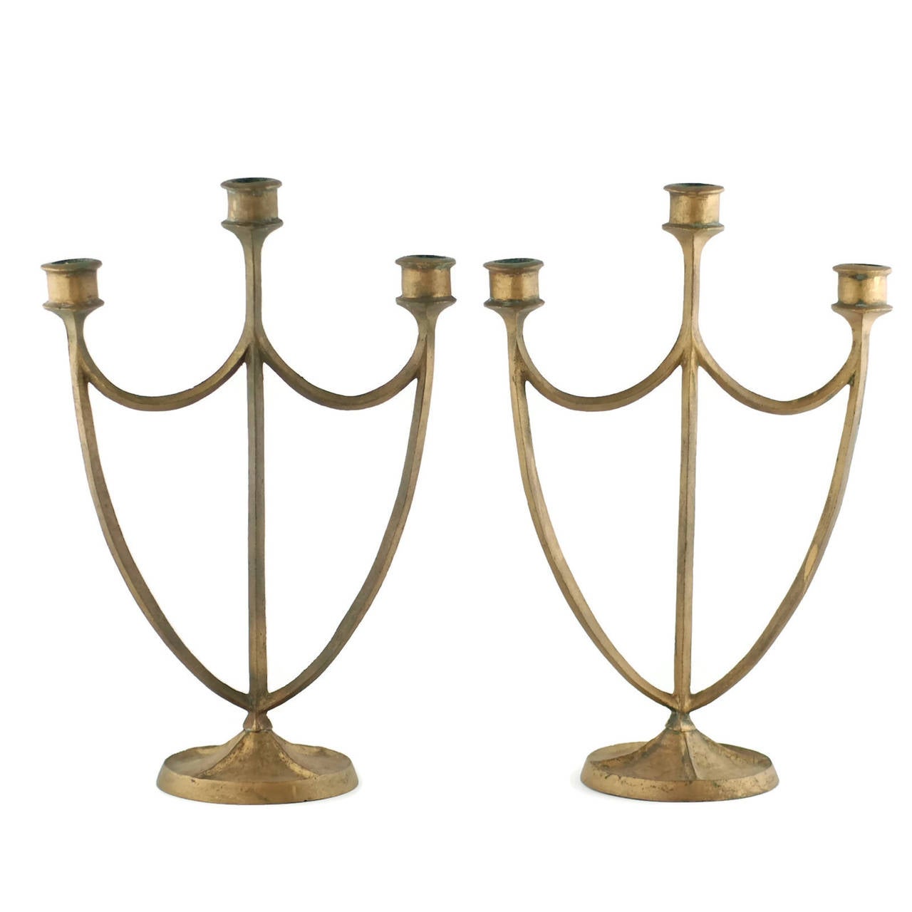 This set of three-arm bronze candelabra was made by multitalented artist and sculptor Edward Timothy Hurley (1869-1950). Hurley studied at the Art Academy of Cincinnati where he excelled in drypoint etching under the tutelage of noted painter Frank