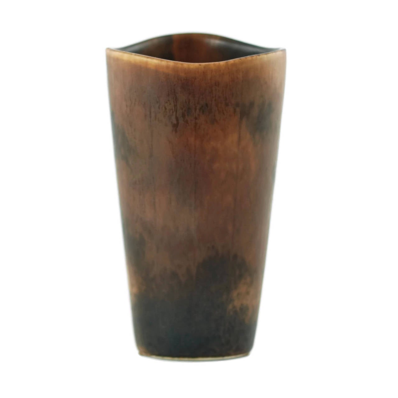This stoneware vase was made by Rörstrand of Sweden, founded in 1726. The piece was designed by Gunnar Nylund (1904-1997), Rörstrand's artistic director. The vase has a rounded triangular form with a scalloped edge rim and is finished in a mottled