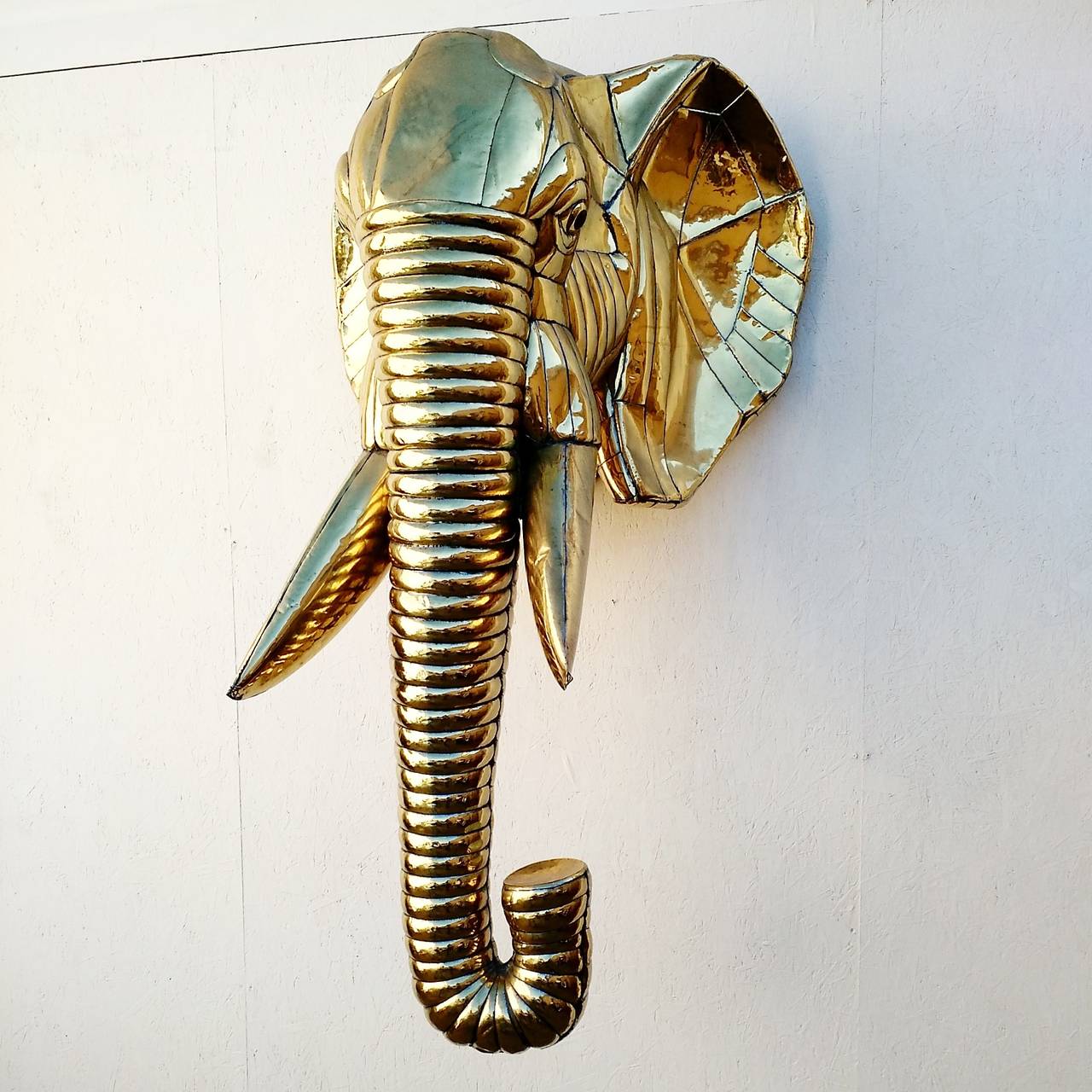 Fabulous lifesize elephant head sculpture, Mexico, circa 1970s.
Designed by Sergio Bustamante done in gleaming brass.
At 6' tall and 3' wide it is a striking piece of modernist art.
Unsigned.