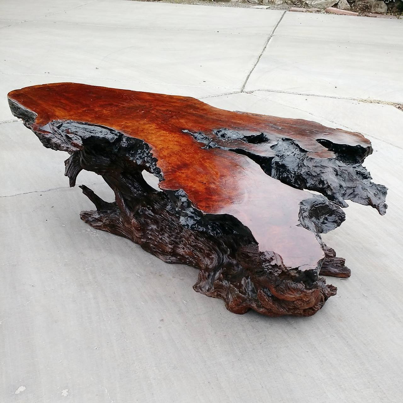 An exceptionally artful and large vintage burl wood coffee table with natural stump base.
Top and base mate together perfectly in design and function.
High gloss finish.
Hidden pegs hold top in place (removable to ease in moving).
Solid, stabile