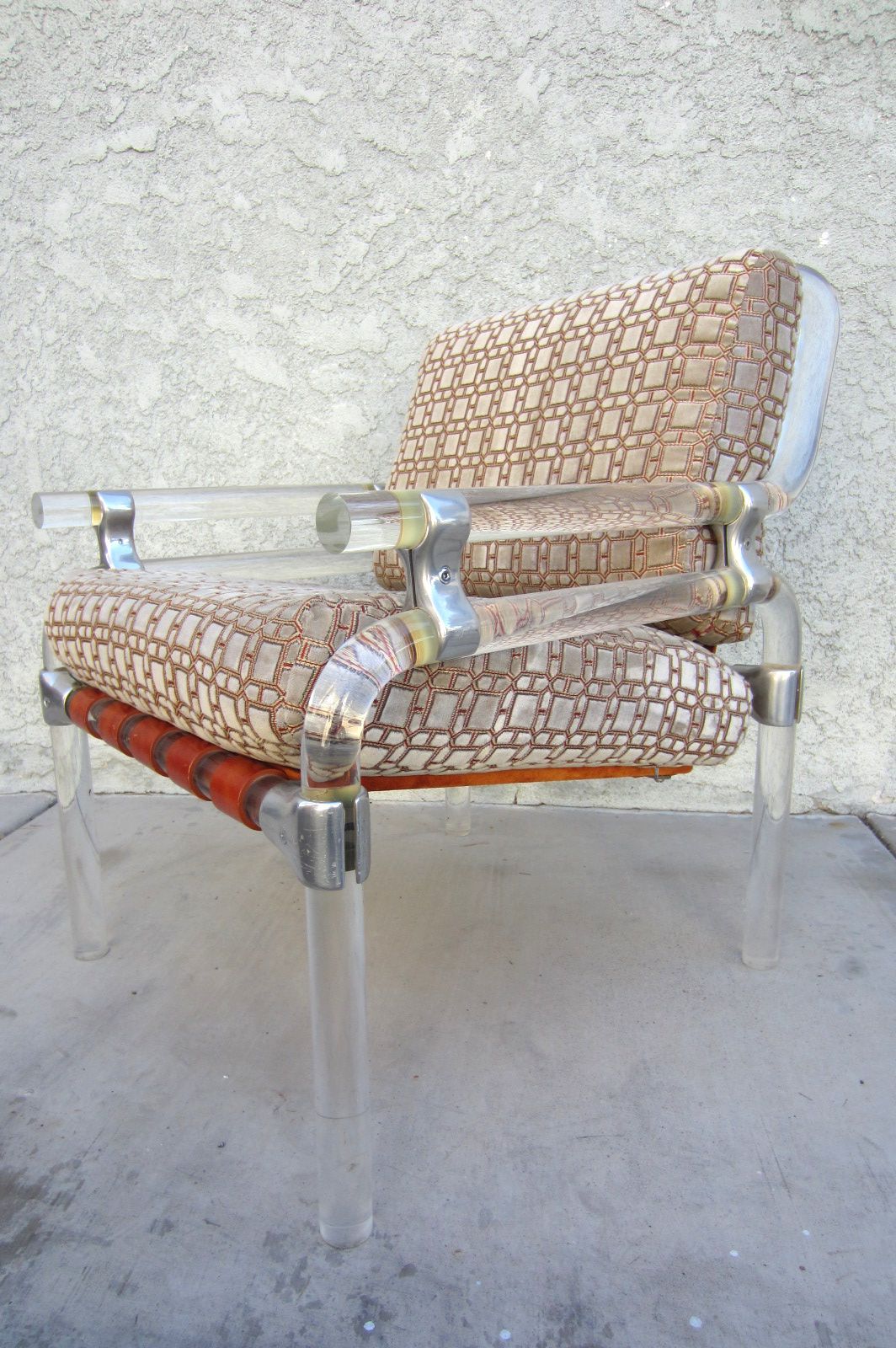 A pair of Pipeline series Lucite lounge chairs by Jeff Messerschmidt, USA, 1970s
Constructed of thick Lucite pipe connected with stainless steel.
Soft brown leather straps and platform hold soft velvet cushions. Very comfortable.
Each is signed and