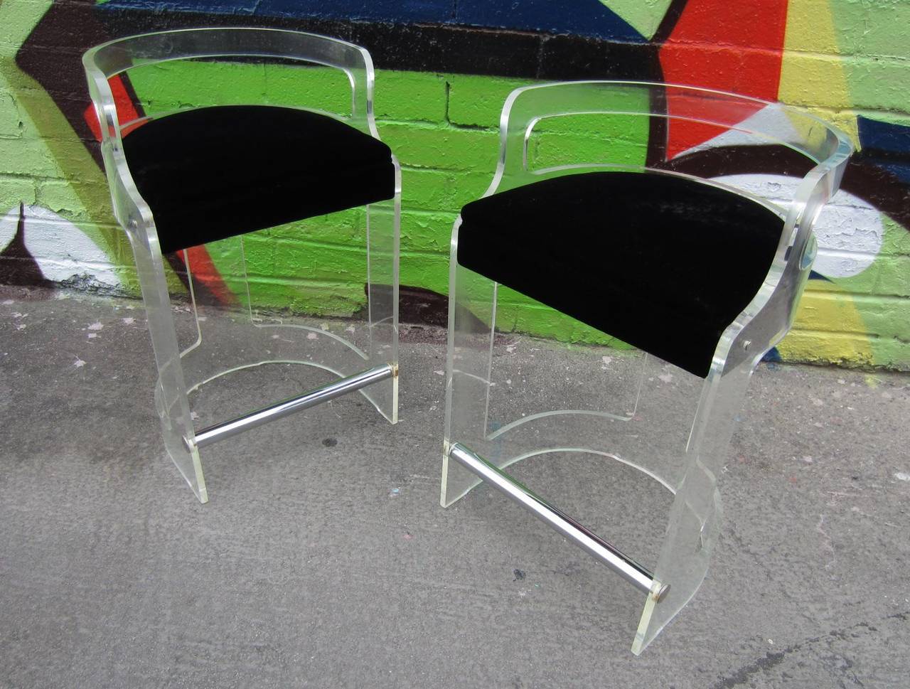 2 Lucite bar stools designed by Charles Hollis Jones with chrome foot rest
upholstered in black velvet.
Circa 1970's