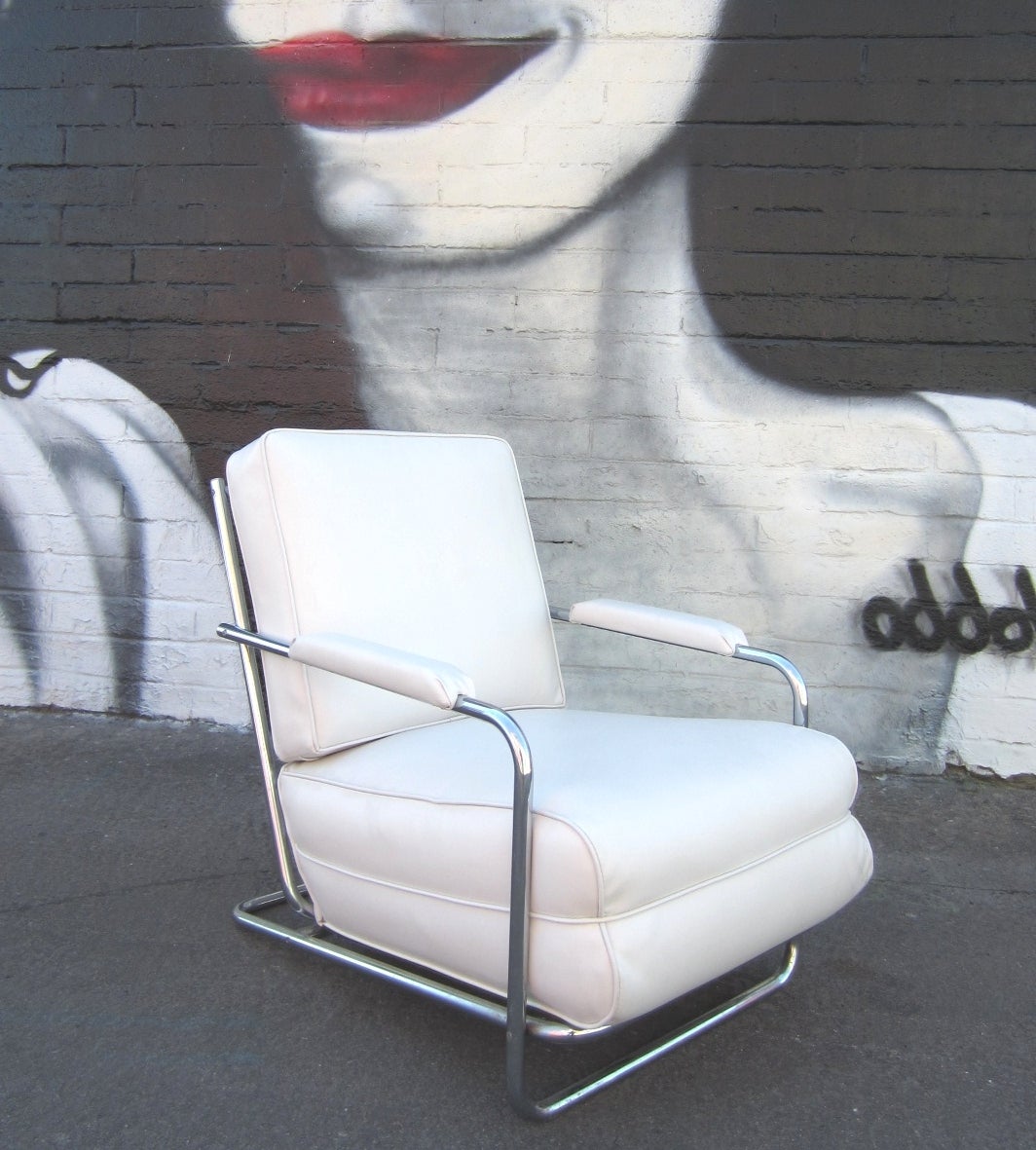 Gilbert Rohde design chrome tubing lounge chair by the Troy Sunshade Company, circa 1930s.
Newly upholstered in pure white vinyl over it's original cotton batting and horsehair cushion.
