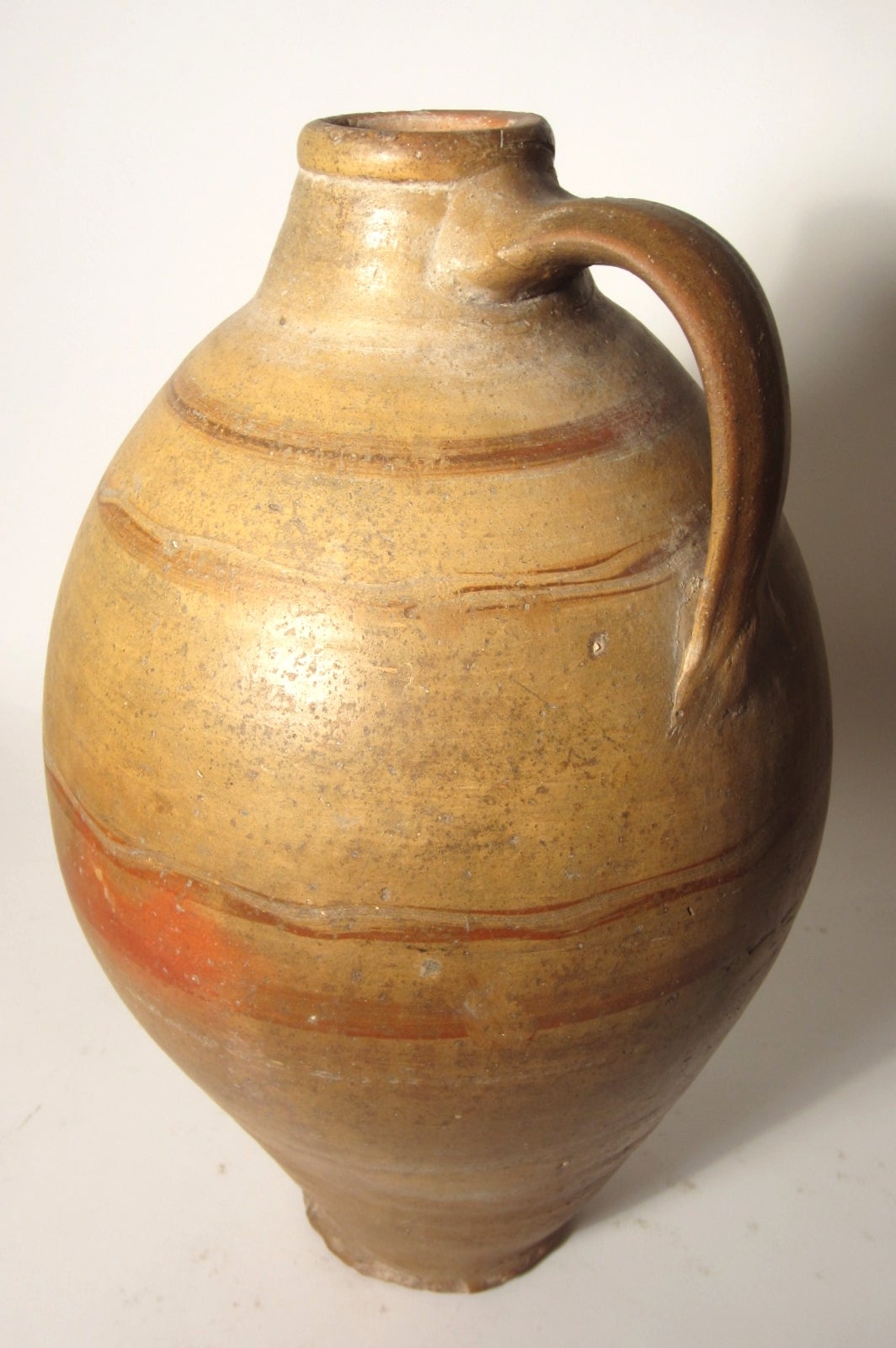 Incredible pair of large terracotta oil jugs in a polished finish.
We're not experts in this field but these look to be ancient(B.C.)clay pieces.
Perfect as interior decor, they have a wonderful soulful color and patina.
