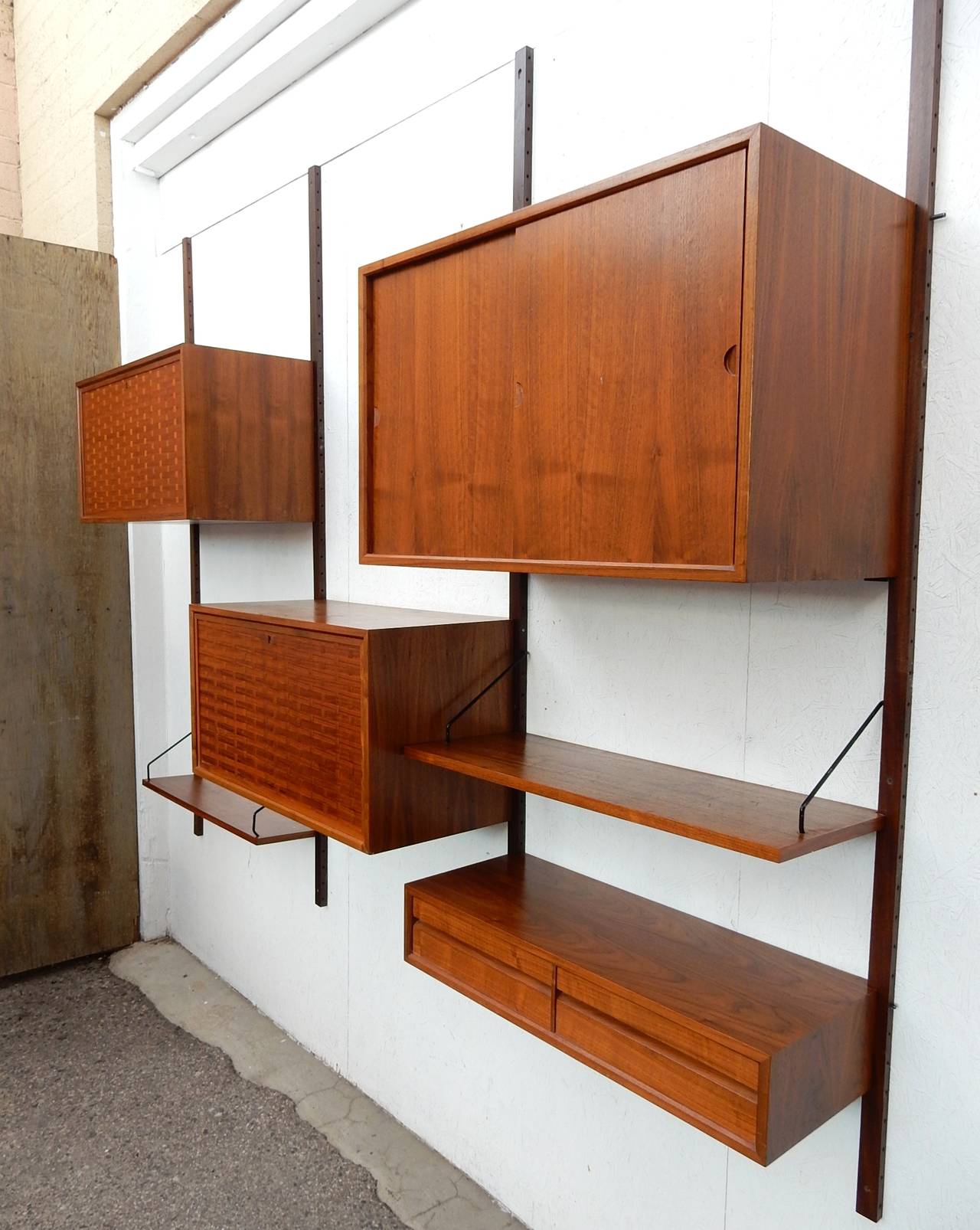 1960's Danish modern wall unit designed by Poul Cadovius. 
Constructed of gorgeous teakwood. Marked 