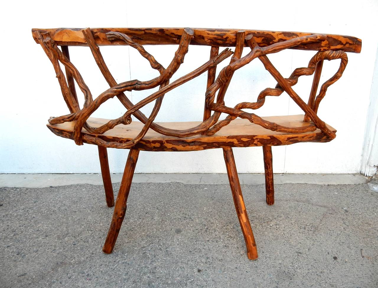 An incredible piece of organic art furniture sculpted of thick curved slaps of Mahogany and masterfully decorated across the front with ancient twisted grapevines. French origin, circa 1940.
A set of 3 matching stools completes the rare and amazing