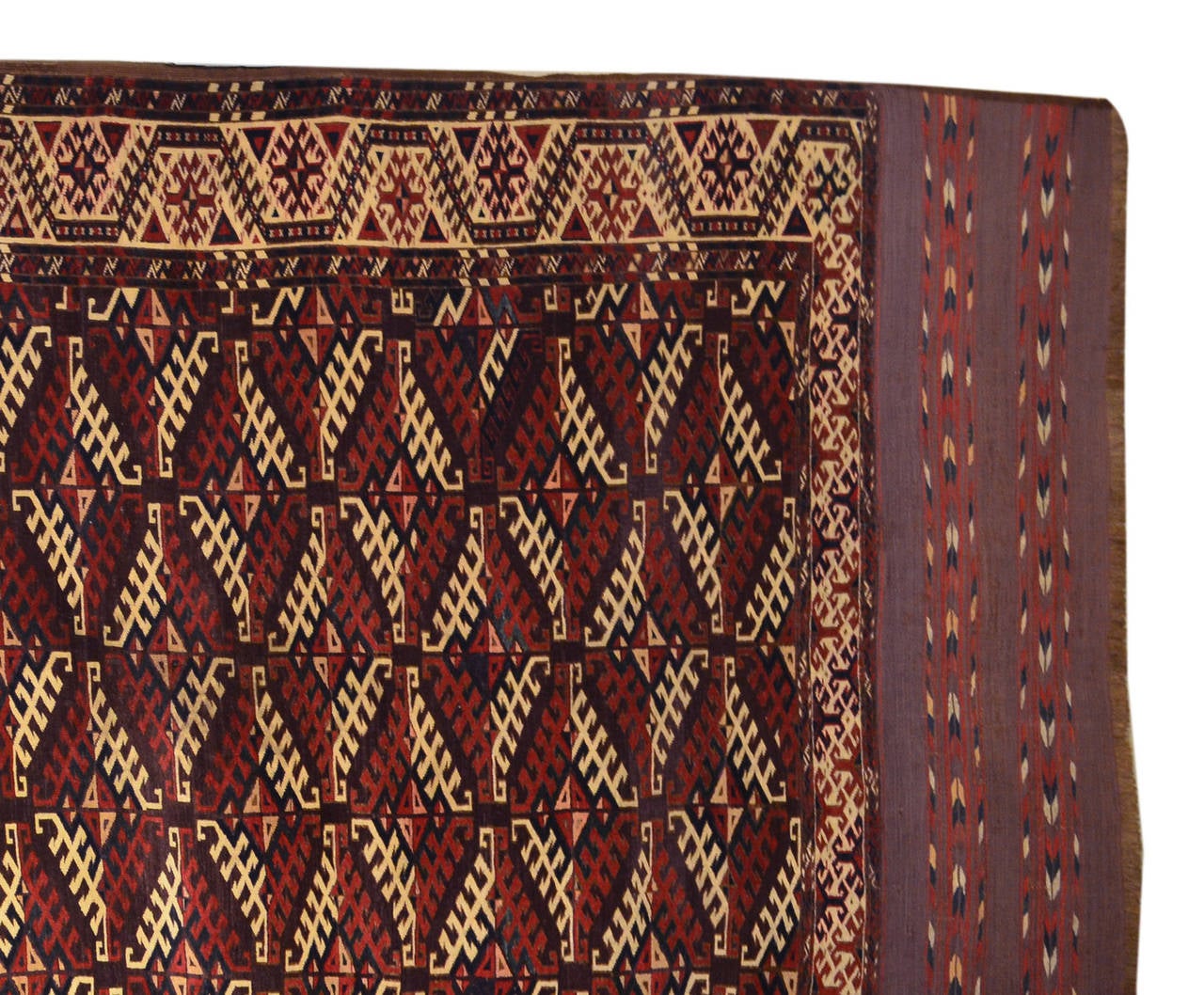 This carpet has been knotted by the Yomut tribe of Turkmenstan in the 19th century. Reddish-brown and shades of yellow are often used by this tribe who lived in the desert. It offers a strong pattern formed by lozenges with white and red hatched