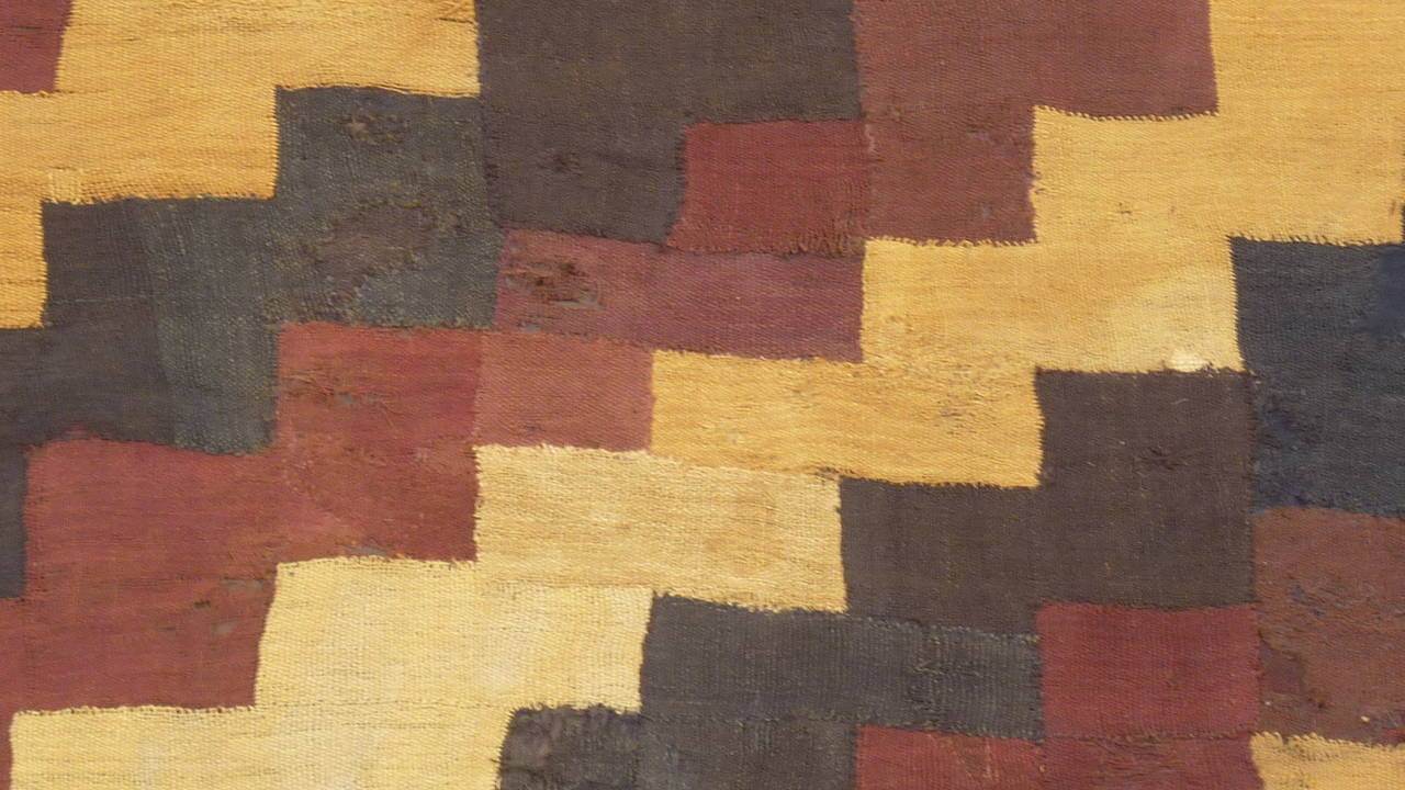 Pre-Colombian Proto-Nazca civilization textile from circa second century AC.
South of Peru.
We love the pleasant well-balanced rhythm of the three colors: Gold-redbrown-darkbrown-nearly black. 
The fascinating, woven graphics seem so