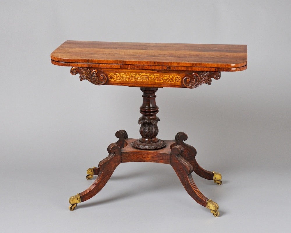 An early 19th century rosewood card table with pretty inlays to the frieze and attractive carved pedestal