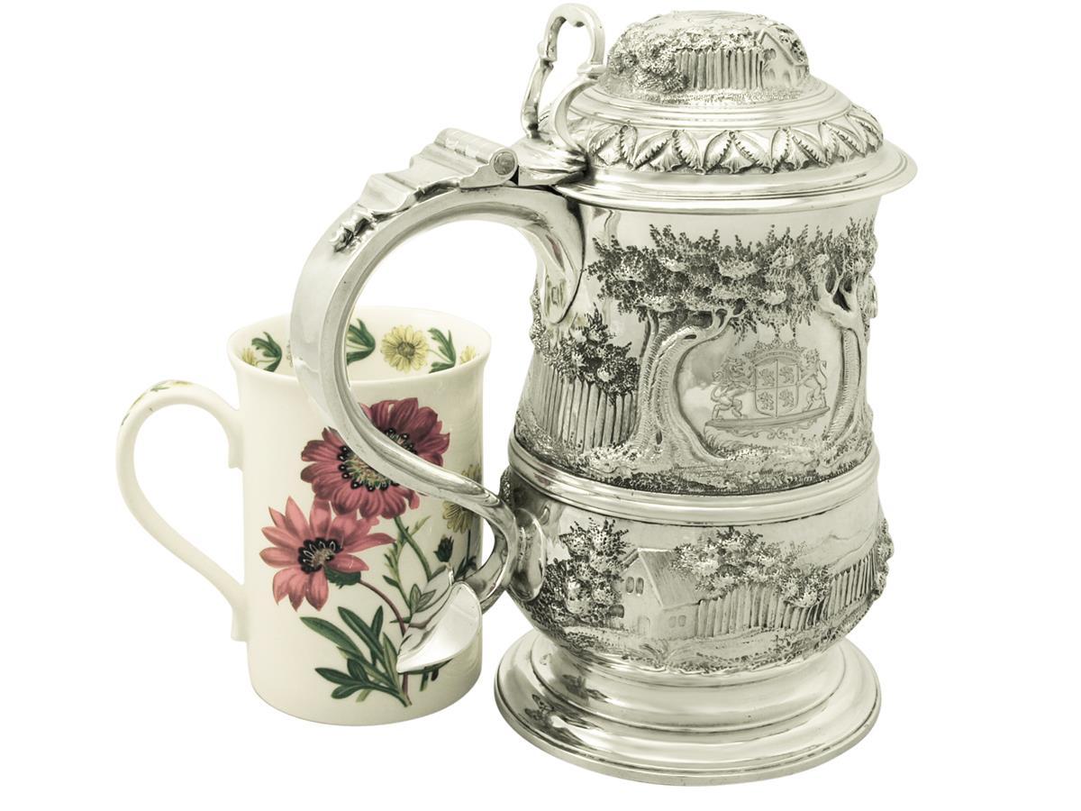 An exceptional, large and impressive antique Georgian English sterling silver baluster shaped quart tankard; an addition to our silver tankard collection.

This exceptional George III sterling silver quart tankard has a plain baluster form onto a