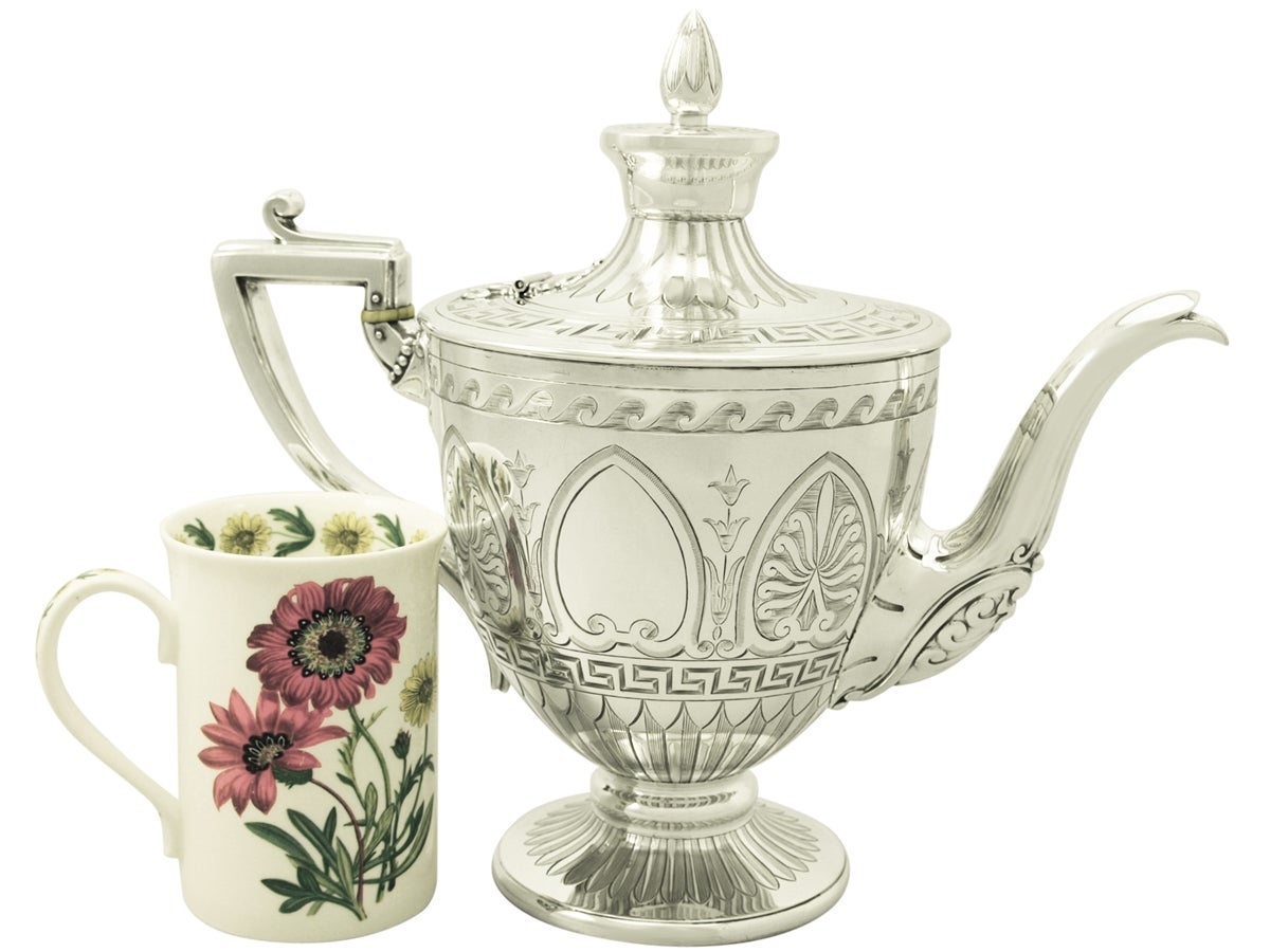 An exceptional, impressive and unusual antique Victorian English sterling silver teapot; an addition to our silver teaware collection.

This exceptional antique sterling silver teapot has a circular bell shaped form onto a circular spreading