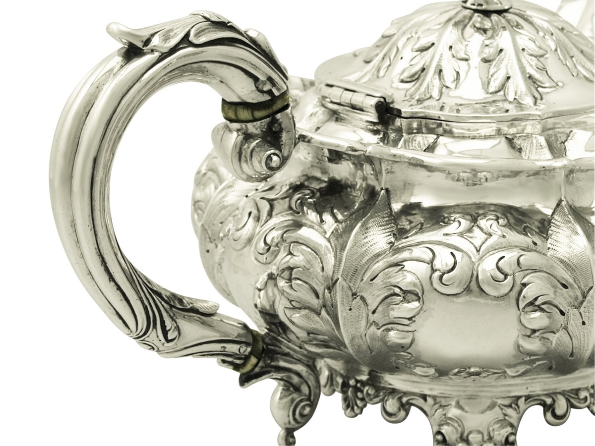 A fine and impressive antique William IV English sterling silver teapot made by Joseph Angell I & John Angell I; an addition to our silver teaware collection.

This fine antique William IV sterling silver teapot has a circular compressed panelled