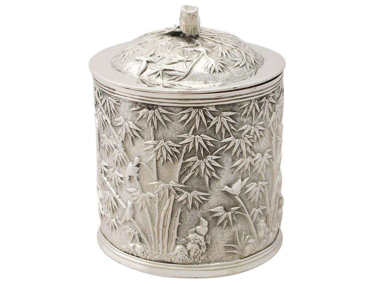 A fine and impressive antique Chinese Export Silver tea caddy; an addition to our diverse silver teaware collection.

This fine antique Chinese Export Silver (CES) tea caddy has a cylindrical form.

The surface of the body is embellished with