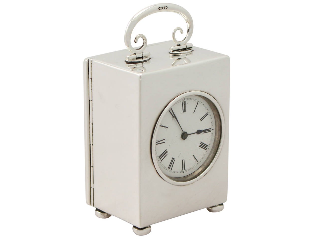 A fine and impressive antique Swiss sterling silver carriage style eight-day boudoir clock; an addition to our silver timepiece collection.

This fine antique sterling silver boudoir clock has a plain rectangular form onto four bun feet.

The