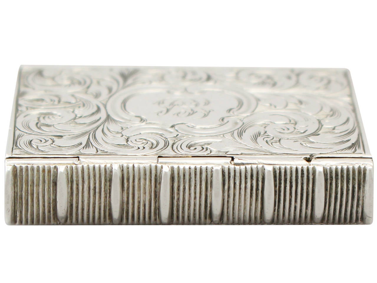 A fine and impressive antique Victorian English sterling silver vinaigrette in the form of a book; an addition to our silver boxes collection

This fine antique Victorian sterling silver vinaigrette has a rectangular form modelled in the form of a