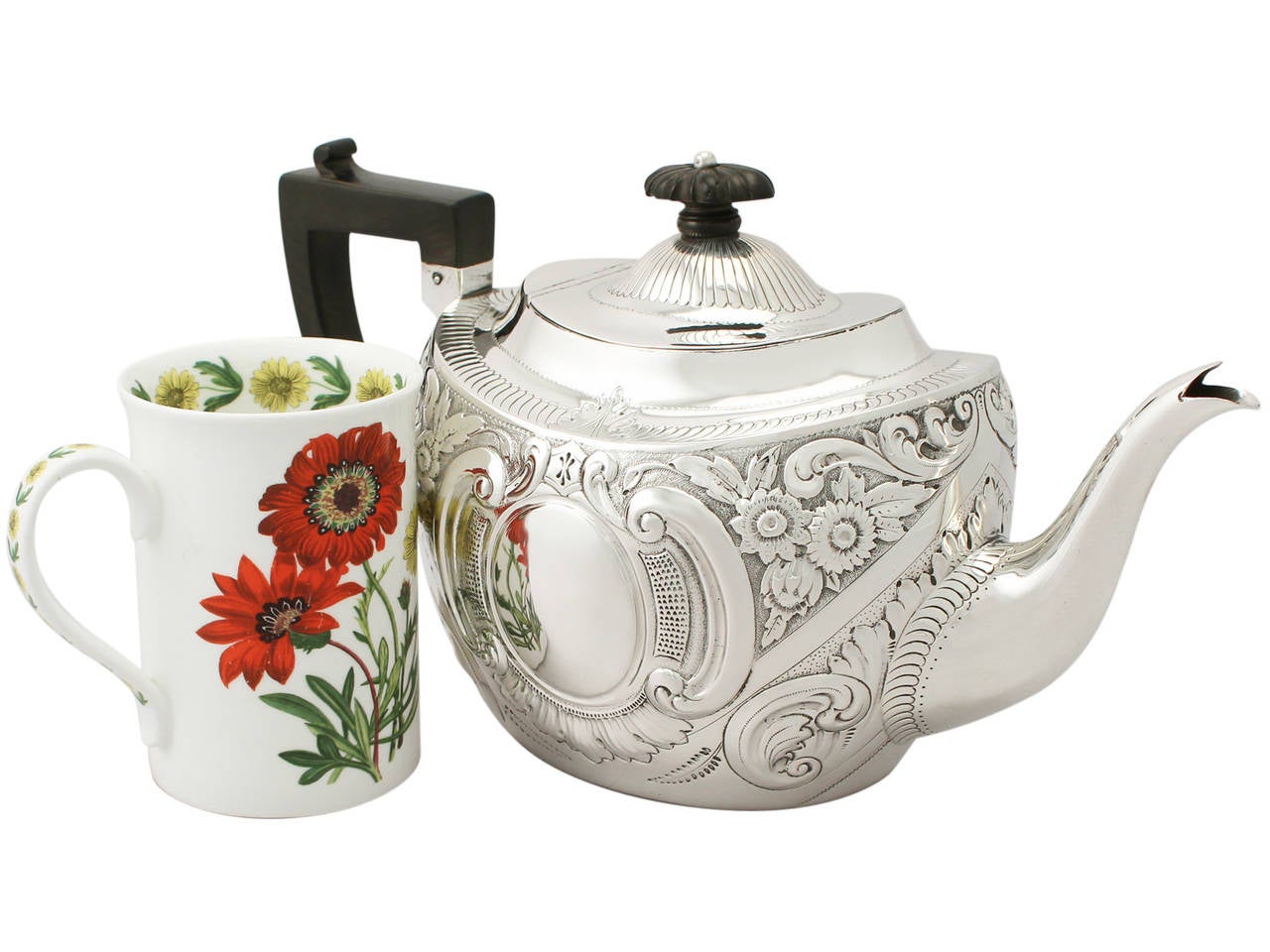 A fine and impressive antique Edwardian English sterling silver teapot; an addition to our silver teaware collection

This fine antique Edwardian sterling silver teapot has an oval rounded form.

The body of the teapot is embellished with embossed