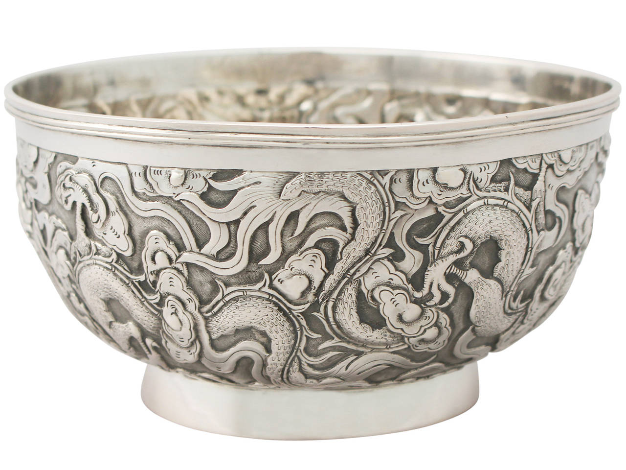 A fine antique Chinese Export Silver bowl; part of our Chinese/Asian silverware collection

This fine Chinese Export Silver (CES) bowl has a plain circular form onto a collet foot.

The body of this antique bowl is embellished with embossed and