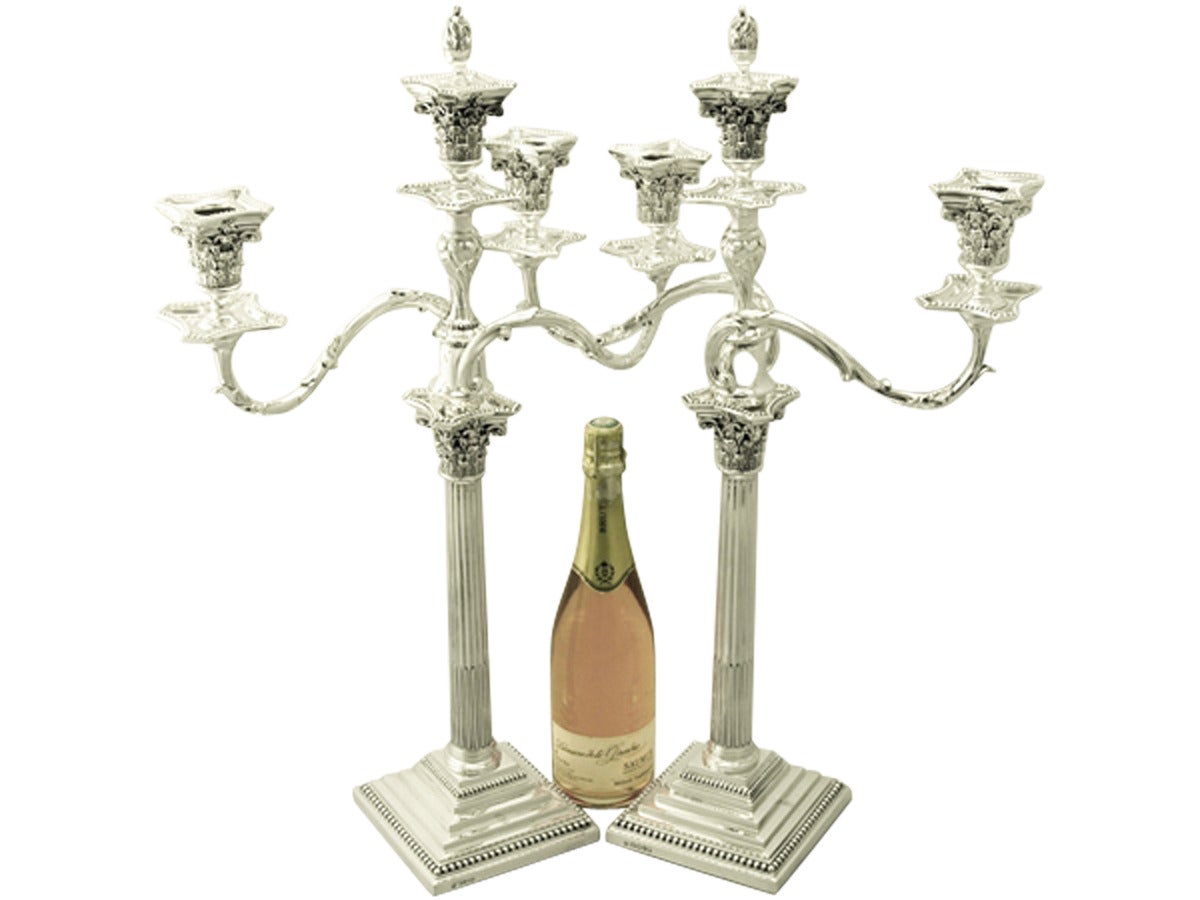 A magnificent, fine and impressive pair of large antique Victorian English sterling silver three-light Corinthian column candelabra; an addition to our ornamental silverware collection.

These magnificent antique Victorian sterling silver