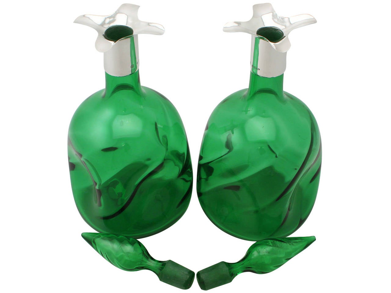 A fine pair of antique Victorian sterling silver and green glass decanters; part of our diverse silver and glassware collection.

These fine antique Victorian green glass decanters have a rounded square shaped form.

The cylindrical neck of each