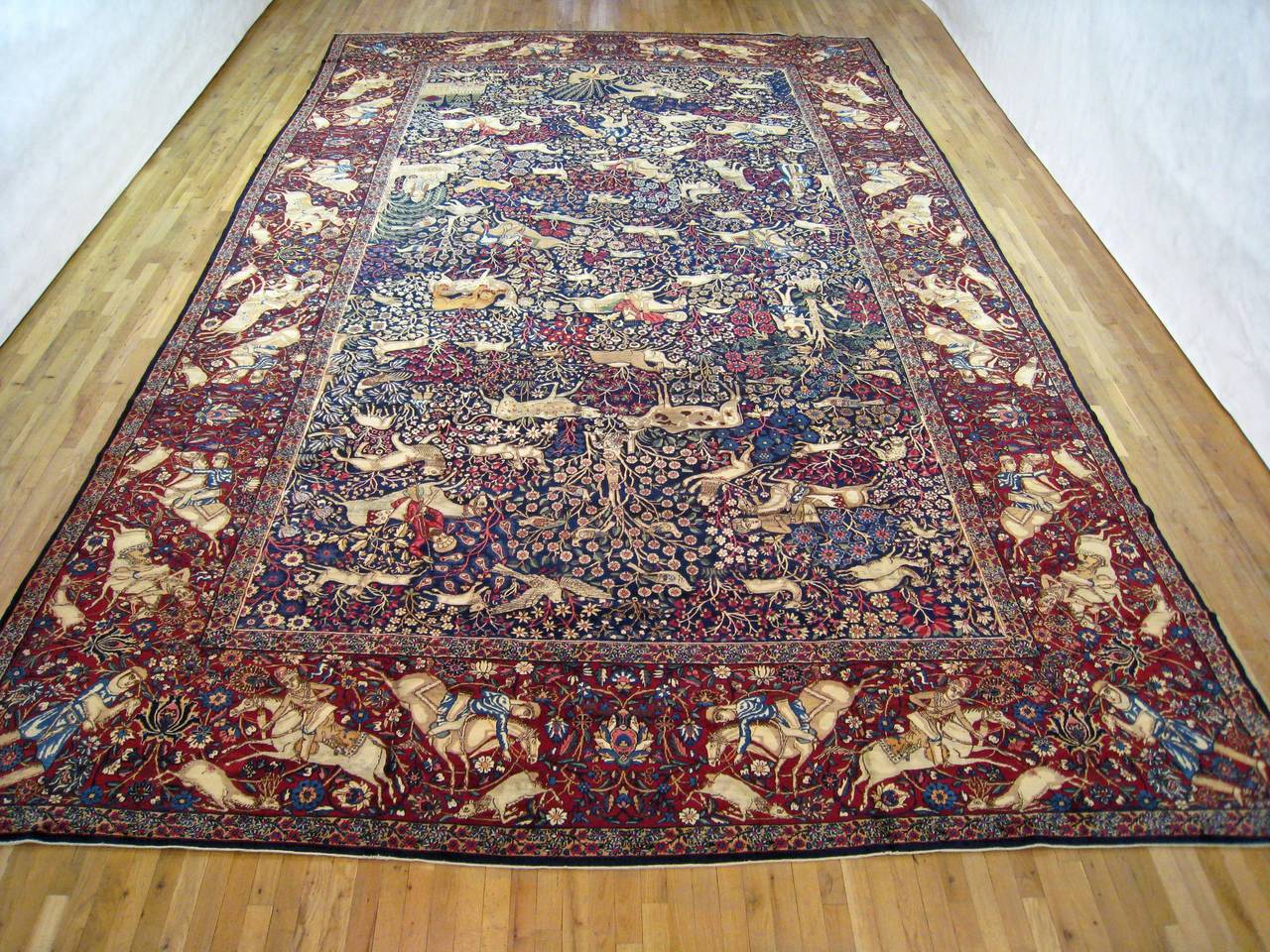 An antique Persian Kerman hunting design oriental carpet, circa 1890, size 19'0