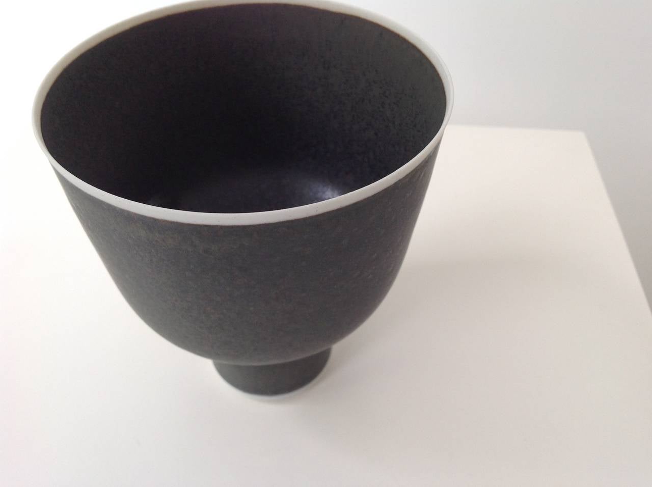 Hand thrown form, one of a kind, small porcelain bowl on foot, white porcelain, black glazed, signed Lap