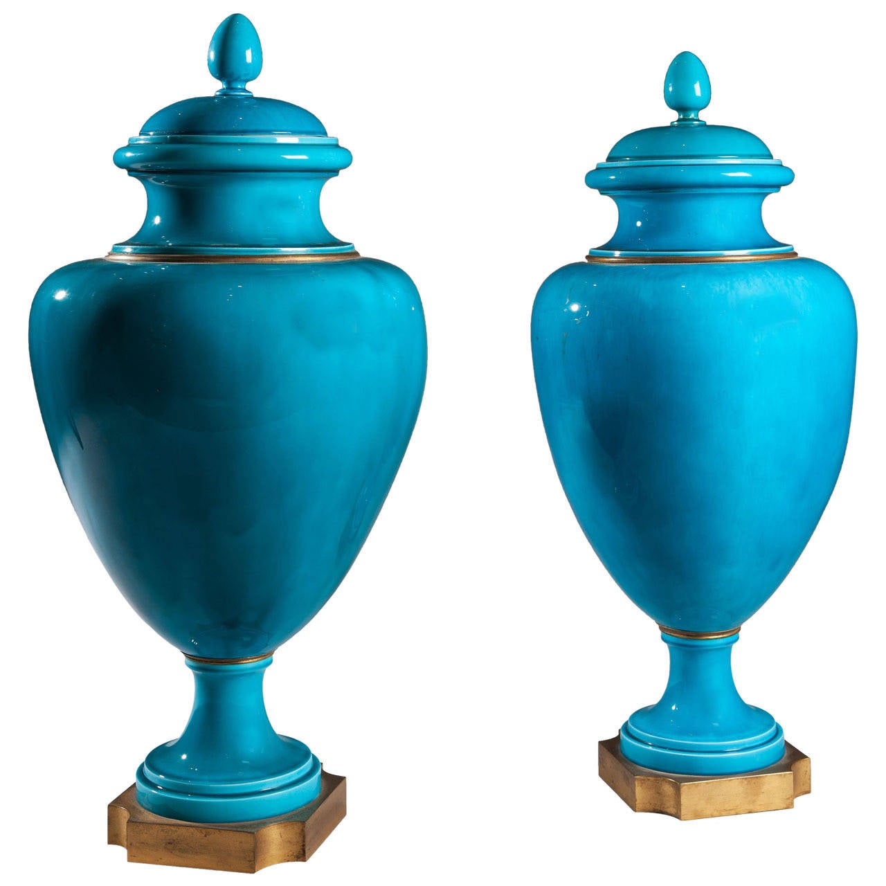 A pair of large-scale turquoise blue vases and covers of baluster form, raised on gilt bronze bases.

These vases are known as Paris vases as recorded at RMN-Grand Palais (Sèvres, Cité de la céramique).