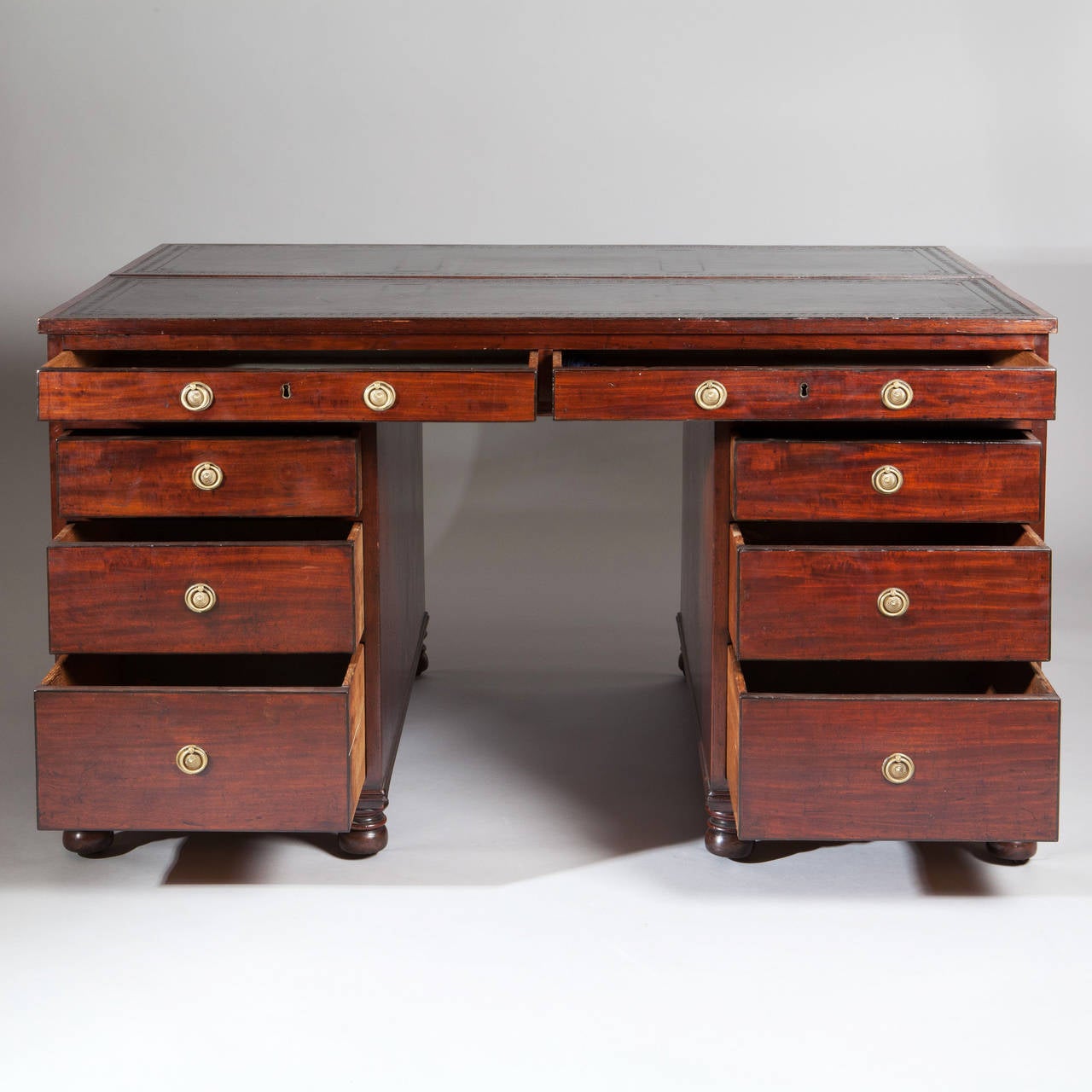 A fine late 18th century George III figured mahogany pedestal architects or library desk, the broad top, divided with two adjustable slopes, above two long drawers on each side, the front side with two banks of three graduated drawers and the other