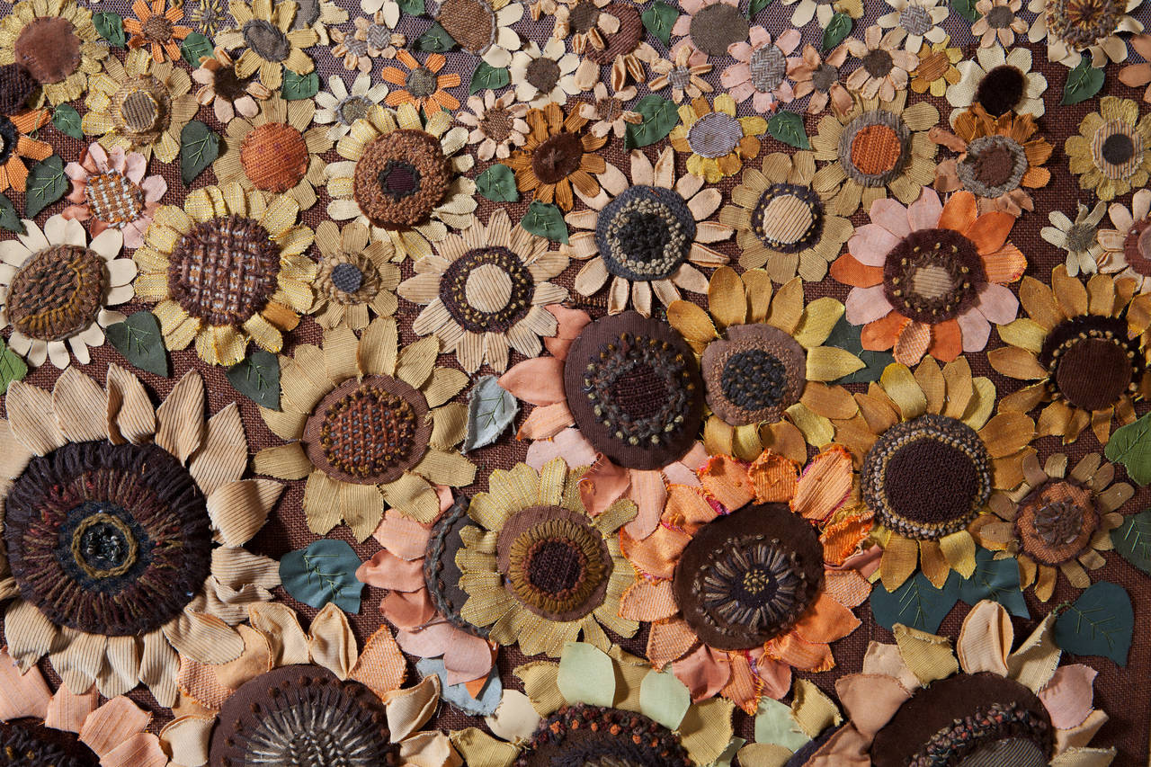 A highly unusual 1960s large scale fabric collage panel depicting a field of sunflowers. The range of flowers from large in the foreground to tiny at the back is achieved in an exaggerated manner.

Signed in embroidery Kendzior.