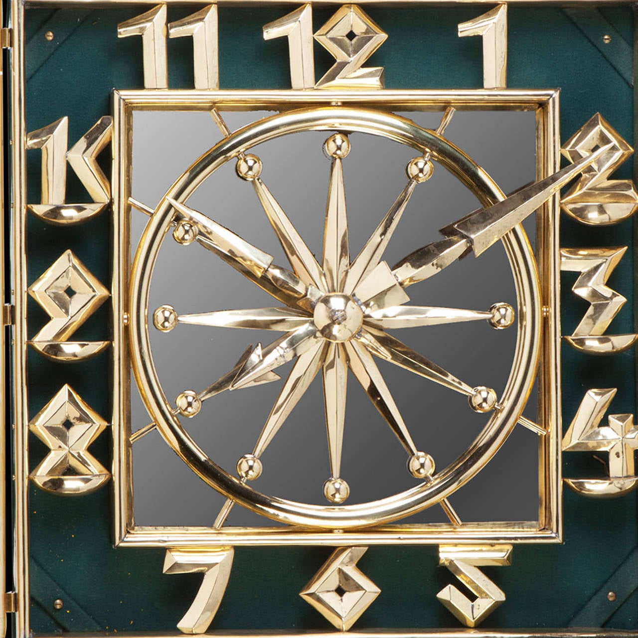 A highly unusual repousse brass Art Deco wall clock, the face having a mirrored back and the frame with bold numbers and supporting scrolls.