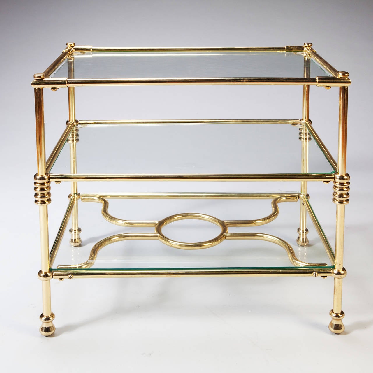 An early 20th century polished brass three-tiered etagere.