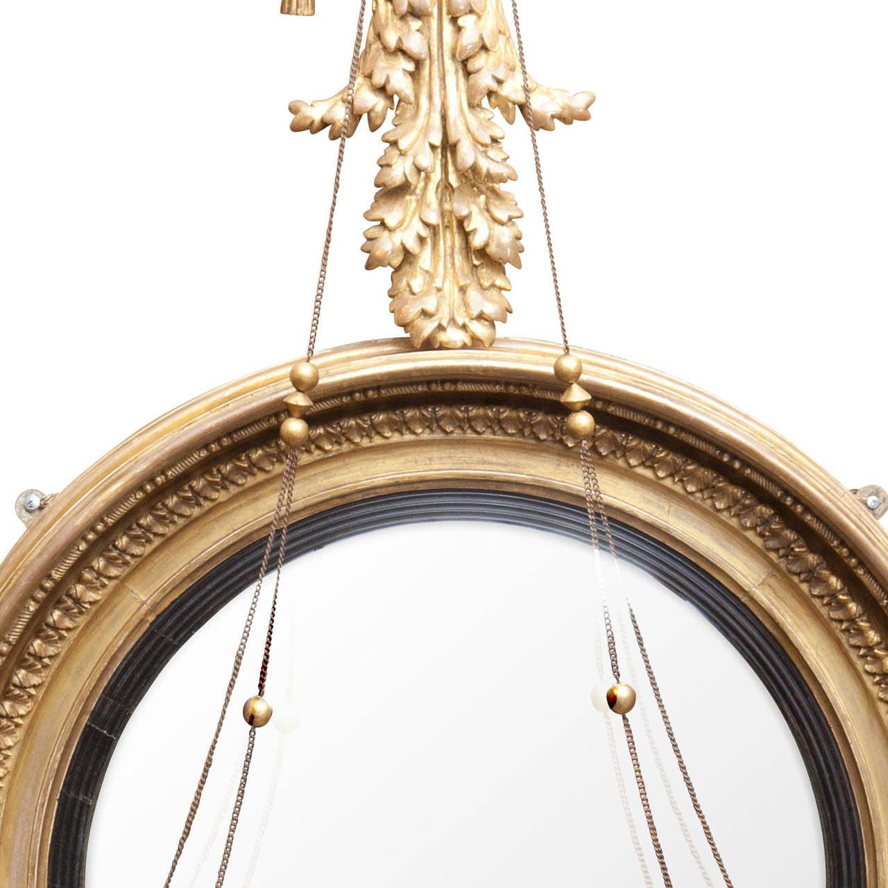 A magnificent and very large early 19th century convex mirror, the large convex mirror flanked by broad candle arms and the whole surmounted by a finely carved and gilt eagle. 

  