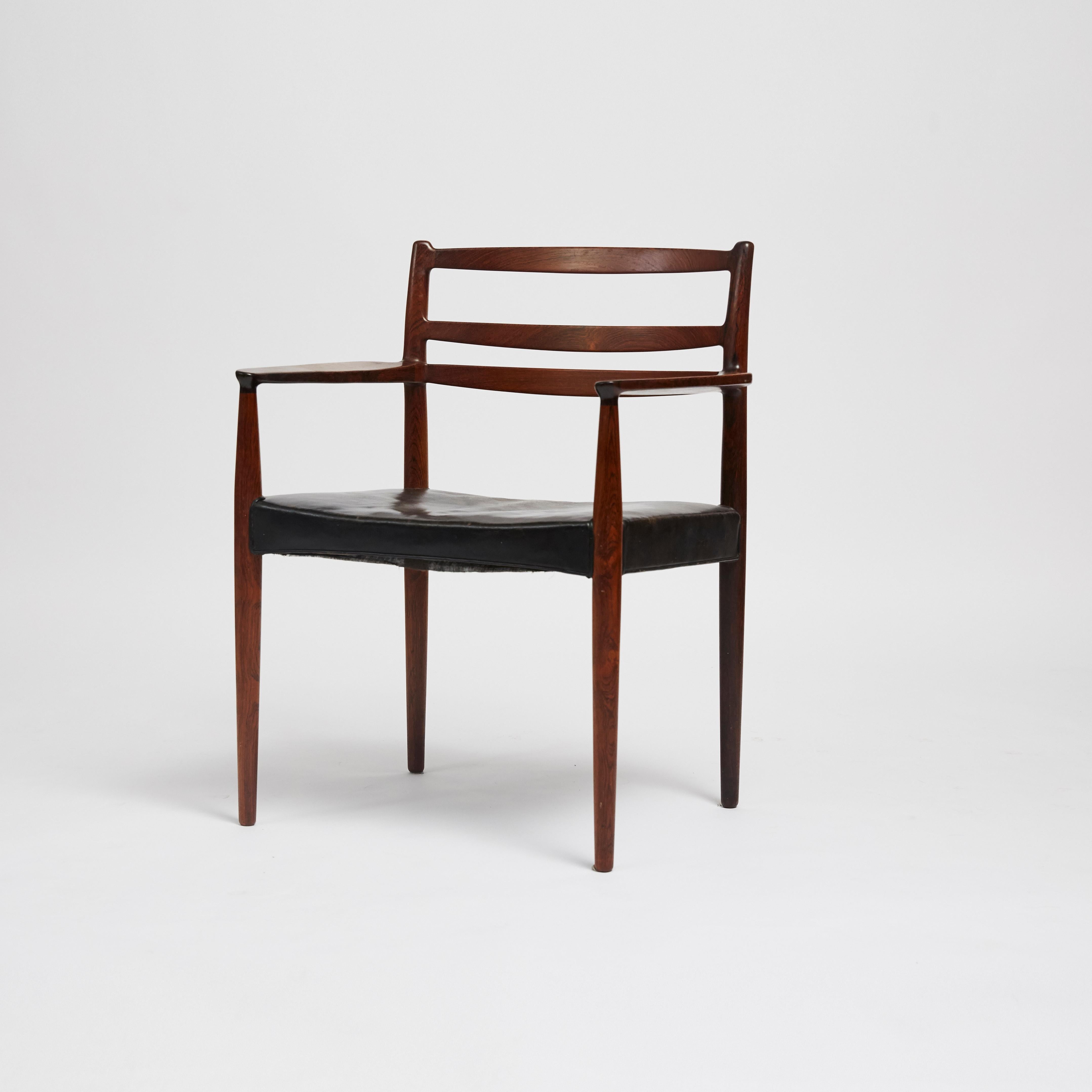 A set of eight 1960s Danish dining chairs with solid rosewood frame and original black leather upholstery attributed to Erik Wortz. Leather upholstery and wood show some marks and fading, consistent with age and use.

Measures: Two armchairs:
W