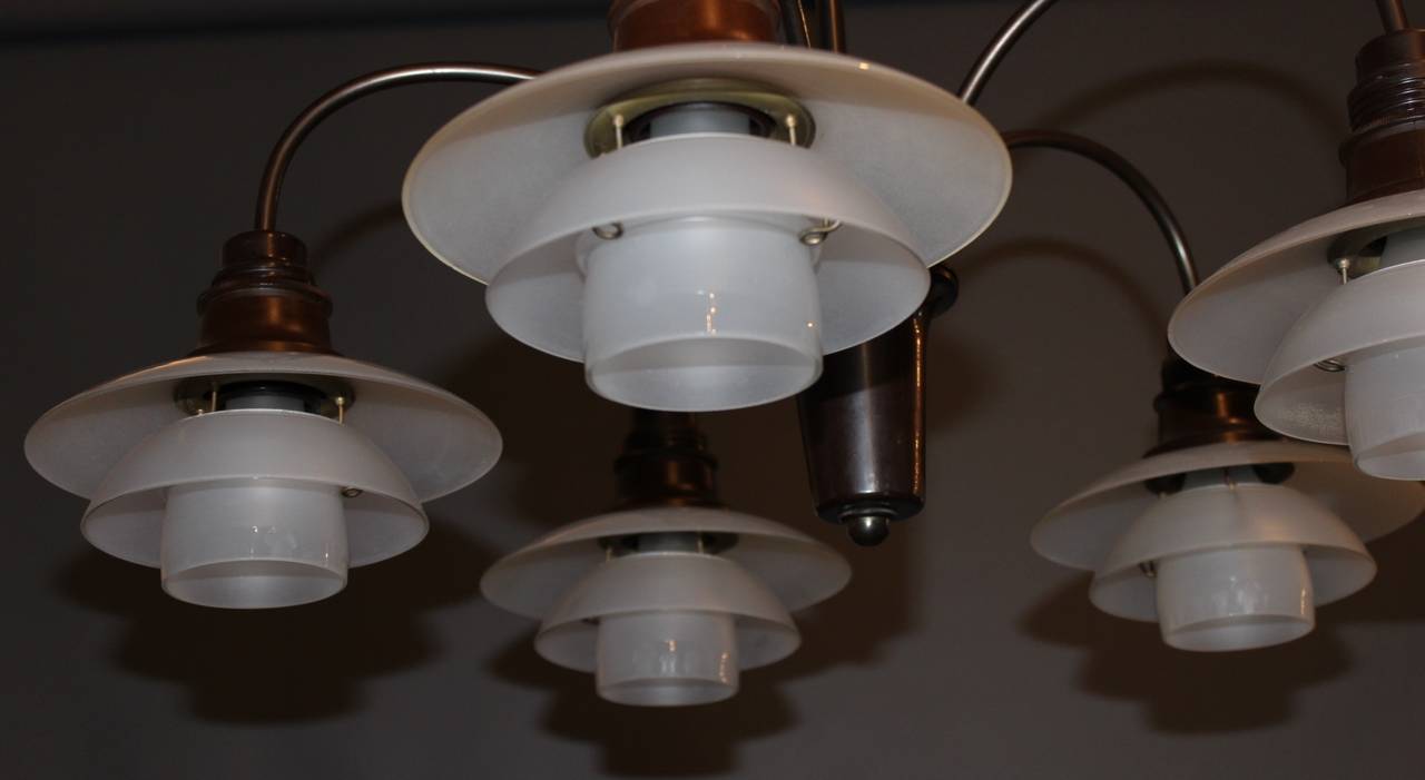 This rare chandelier By Poul Henningsen is with handblown frosted glas shades and burnished brass, sockets in bakelite.