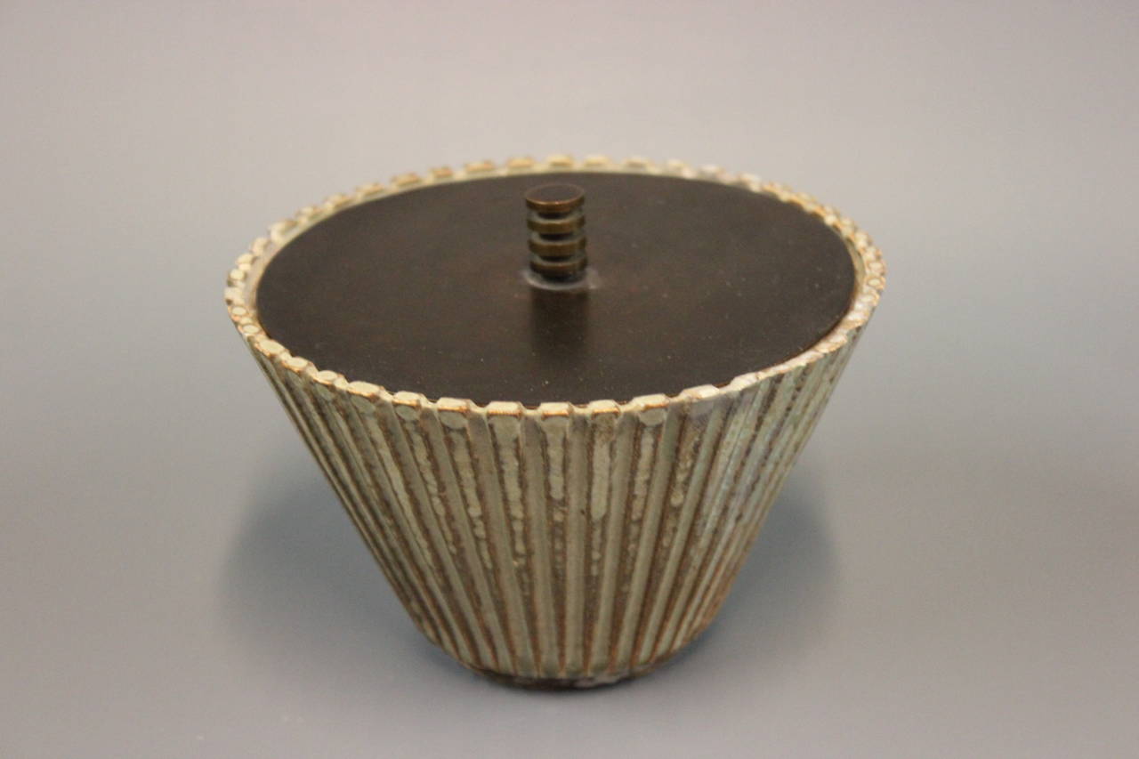 Bowl By Arne Bang with Monogram AB 119. Mounted with lid of Bronze. The bowl is in ribbed stoneware, and glaze in green and brown. From c. 1950s.