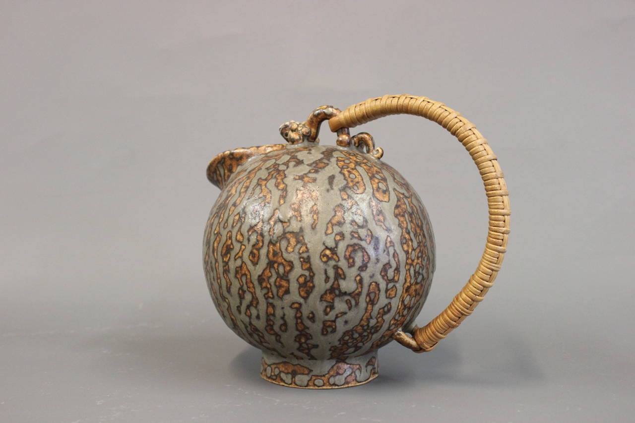 Arne Bang jug in stoneware number 151. With a paper cord handle and glazed in gray and brown, circa 1940-1960.