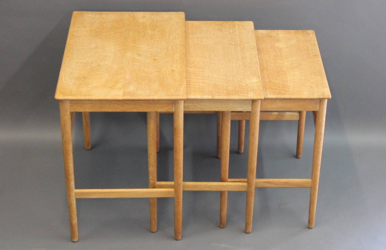A set of nesting tables, model AT 40, in solid oak designed by Hans J. Wegner and manufactured by Andreas Tuck. The tables are from the 1960s.