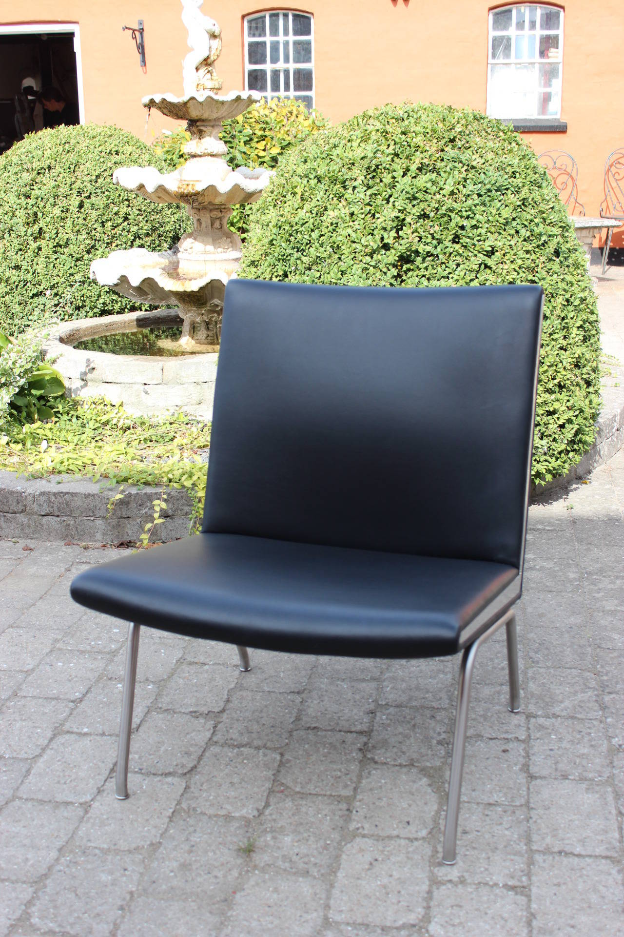 Airport chair, model AP 40, in black leather with stainless steel legs and side. The chair was designed in 1958 by Hans J. Wegner and manufactured by AP Stolen in the 1980s.
