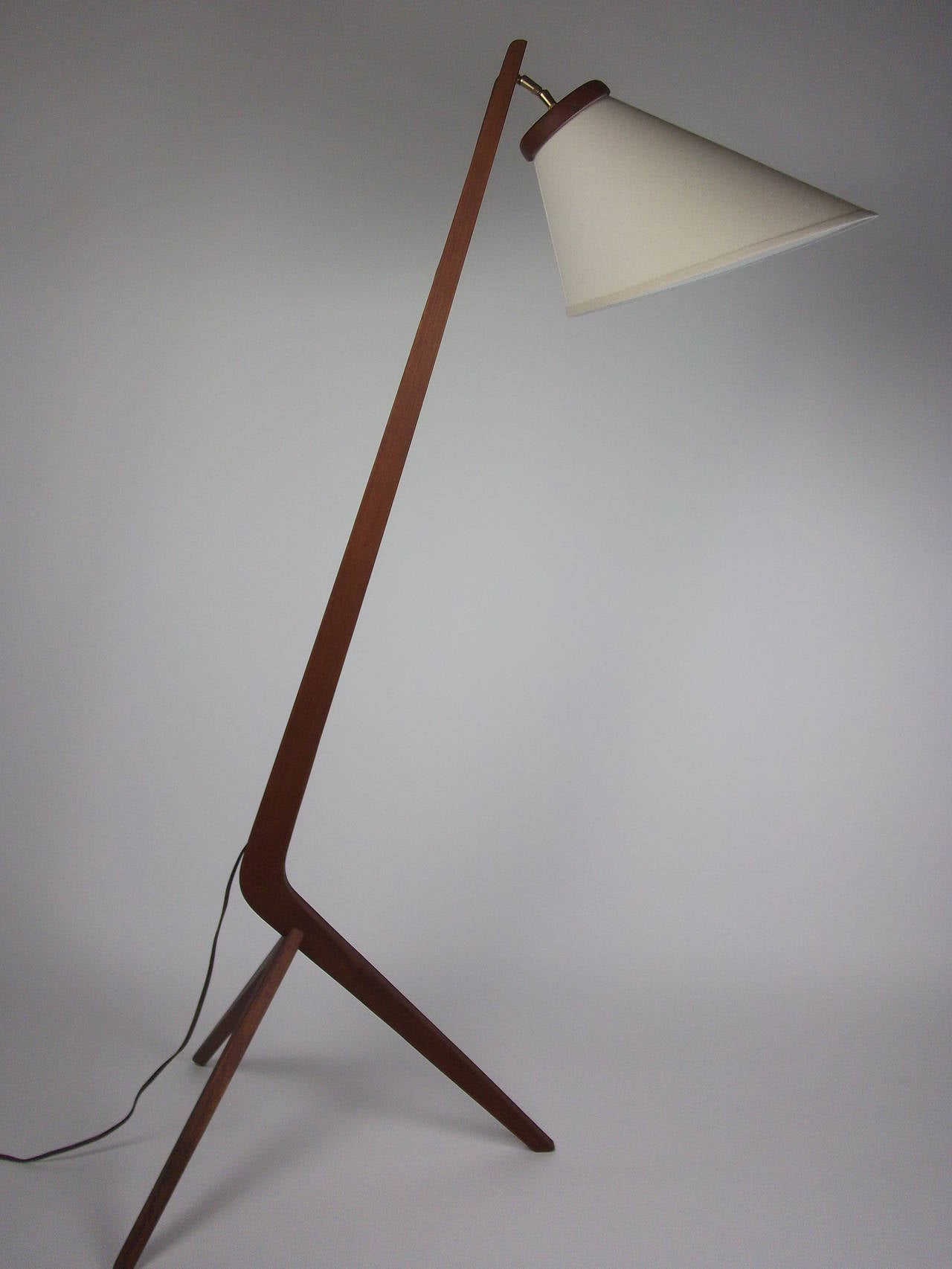 Striking 1960's teak floor lamp  come with a new custom shade made from the original.  Outstanding condition with one small crack on the front leg, barely noticeable and does not affect it structurally, but wanted to mention