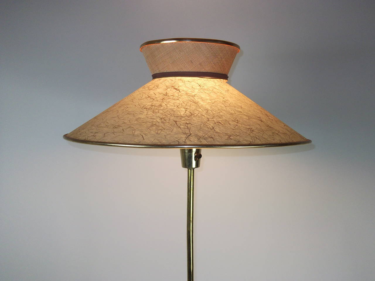 1950's floor lamp Attributed to Gerald Thurston for Lightolier.  Walnut and Brass - Not sure if the shade is original to the lamp, Adjustable height, see pics. Brass feet and neck could use some buffing as it does have some dark age related spots..