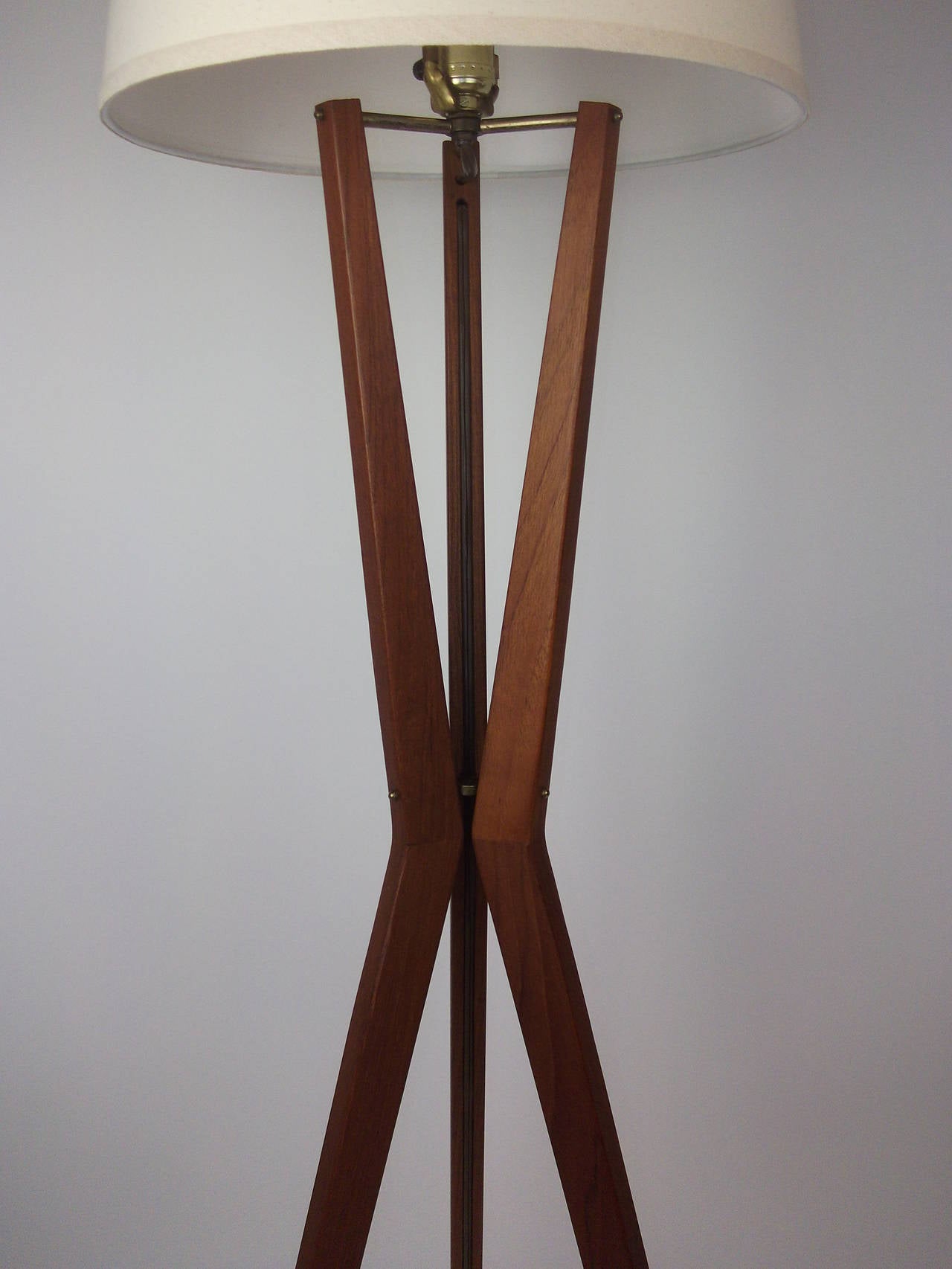 Striking 1960's Danish modern 3 legged teak floor lamp w/ brass detailing (hardware) - made in Denmark - lovely patina - fantastic condition- note one small crack at the top by the brass stretcher - see pic -comes with new custom lamp shade.