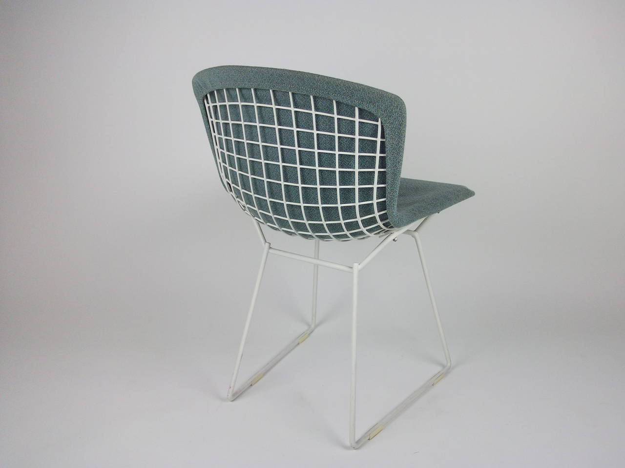 Striking Vintage pair of Wire chairs designed by Harry Bertoia for Knoll - these ones were distributed in Canada - the original baby blue fabric is in amazing vintage condition/  There is minor paint loss under one chair by the bolt - see pic -