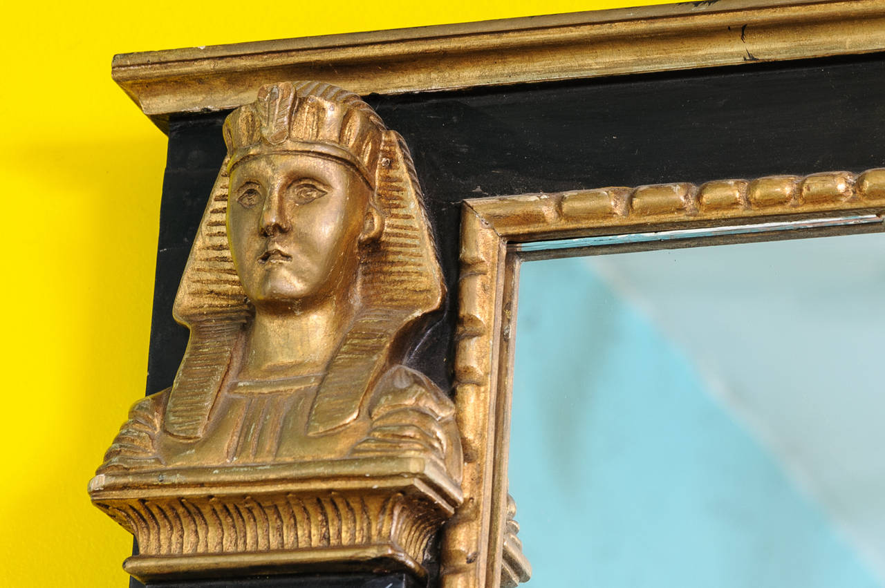 This extraordinary Egyptian Revival XX century mirror features pharaoh gilded busts (or royal males) on the top of faux marble columns on each side of mirror frame. A very impressive dramatic look and size.
Designer piece, continental, probably