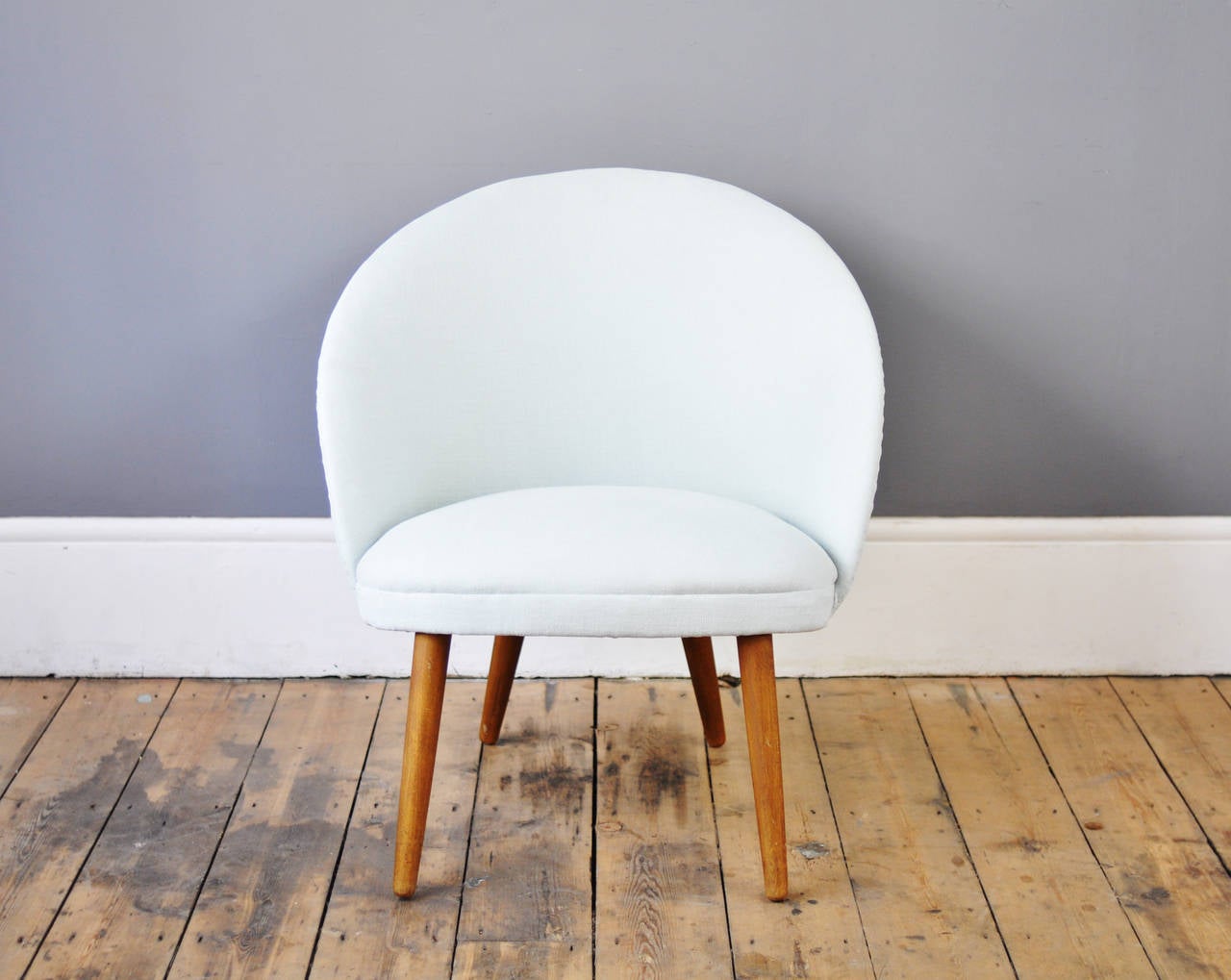 Charming Danish armchair with a softly rounded back providing an enveloping seat. Newly upholstered in ice blue fabric which has been treated for stain resistance.